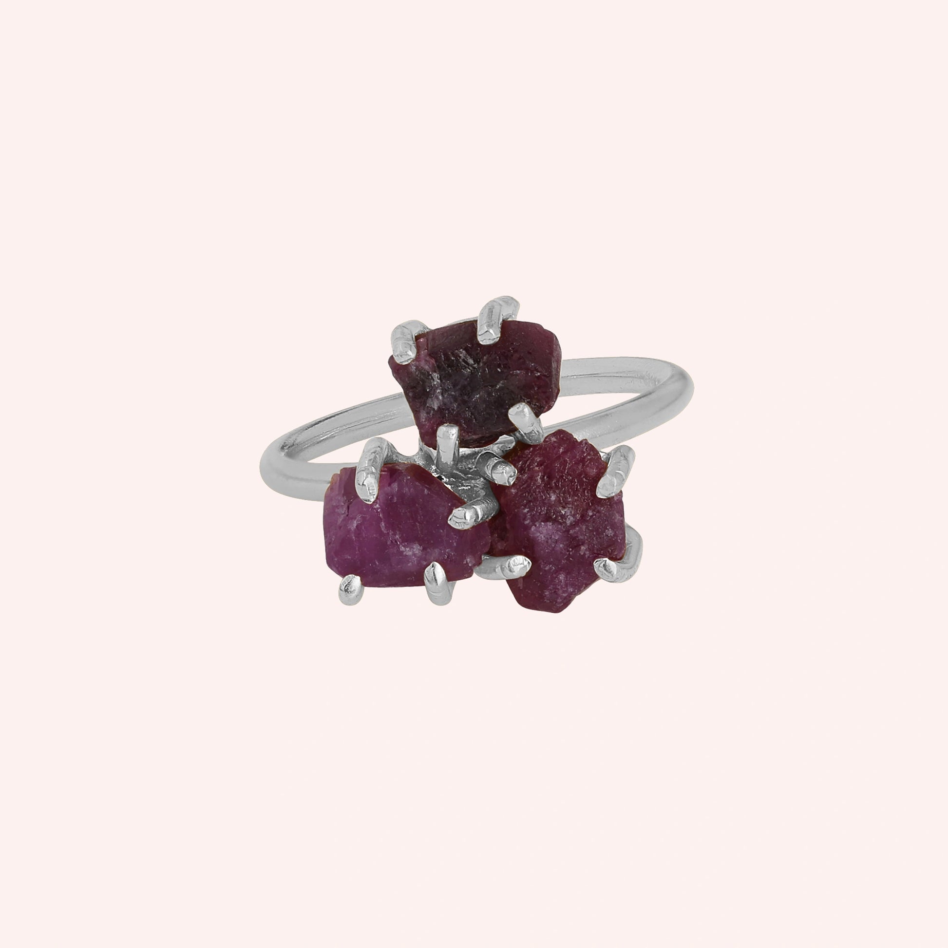 Pink_ring_in_sterling_silver_with_raw_tourmaline_stones_at_front_angle_view_on_solid_pink_background