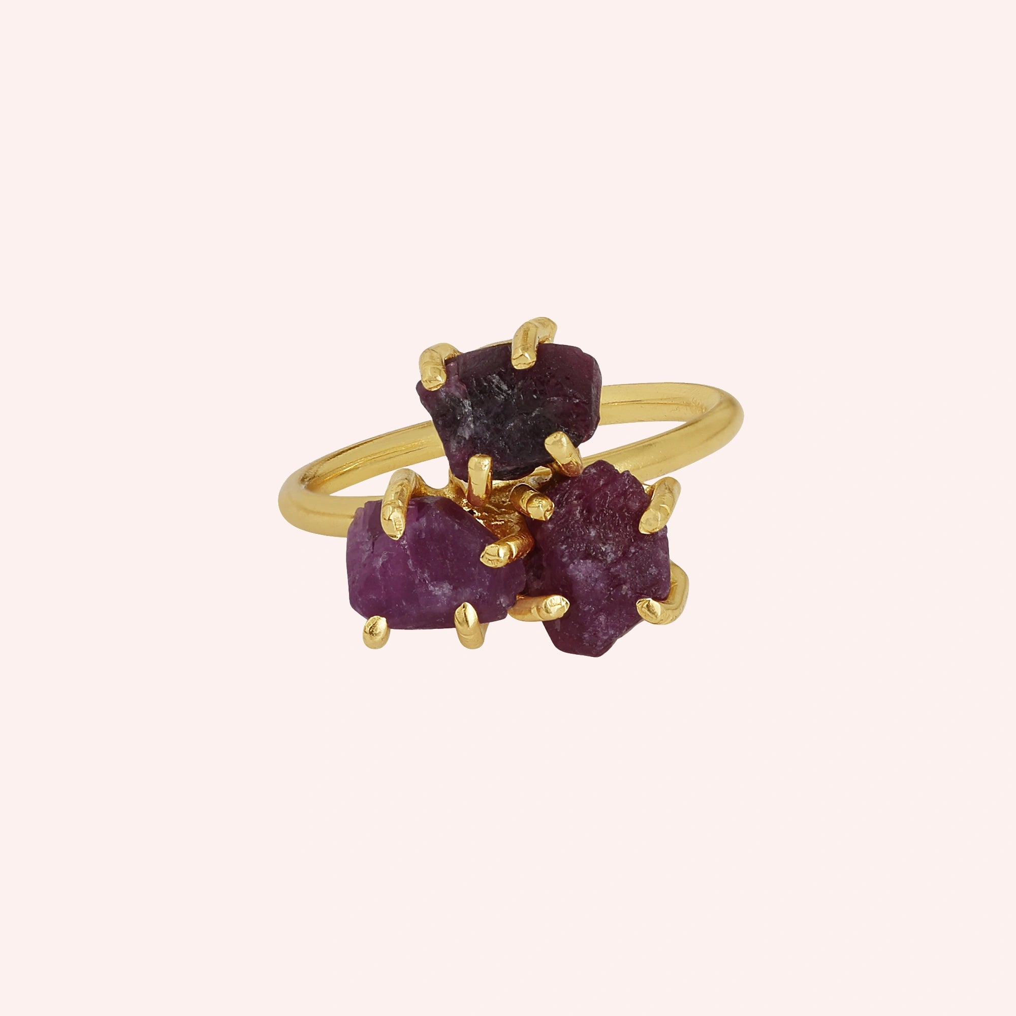 Pink_ring_in_gold_plated_silver_with_raw_tourmaline_stones_at_front_angle_view_on_solid_pink_background