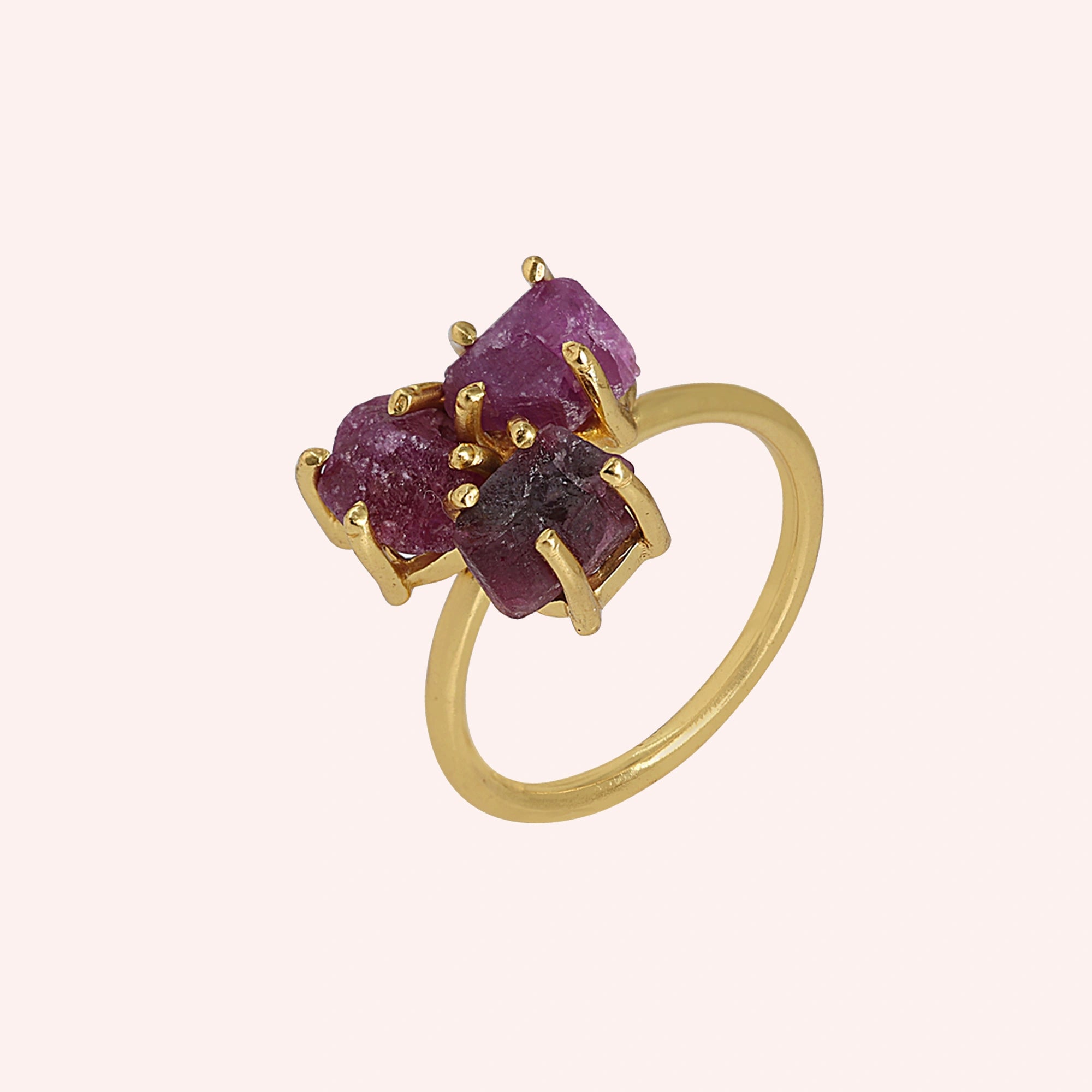 Pink_ring_in_gold_plated_silver_with_raw_tourmaline_stones_at_slight_angle_view_on_solid_pink_background