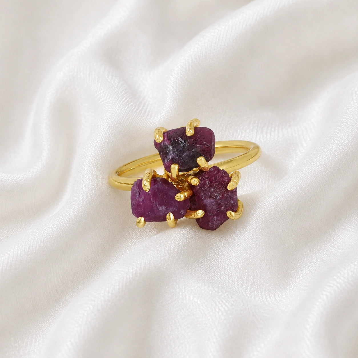 Pink_ring_in_gold_plated_silver_with_raw_tourmaline_stones_at_front_angle_view_on_soft_fabric_background