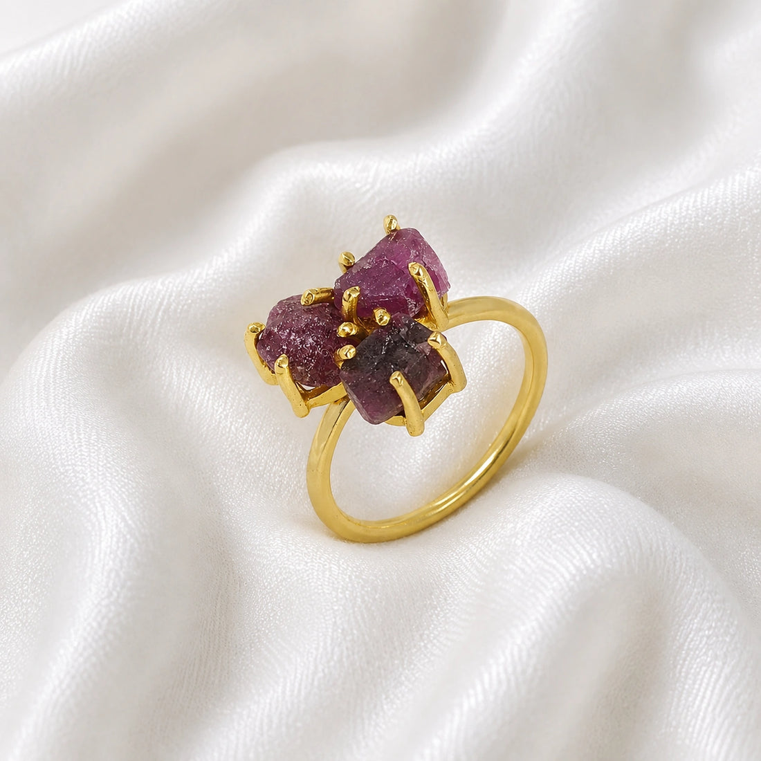 Pink_ring_in_gold_plated_silver_with_raw_tourmaline_stones_at_slight_angle_view_on_soft_fabric_background