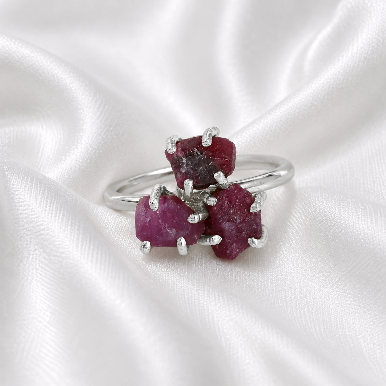 Pink_ring_in_sterling_silver_with_raw_tourmaline_stones_at_front_angle_view_on_soft_fabric_background