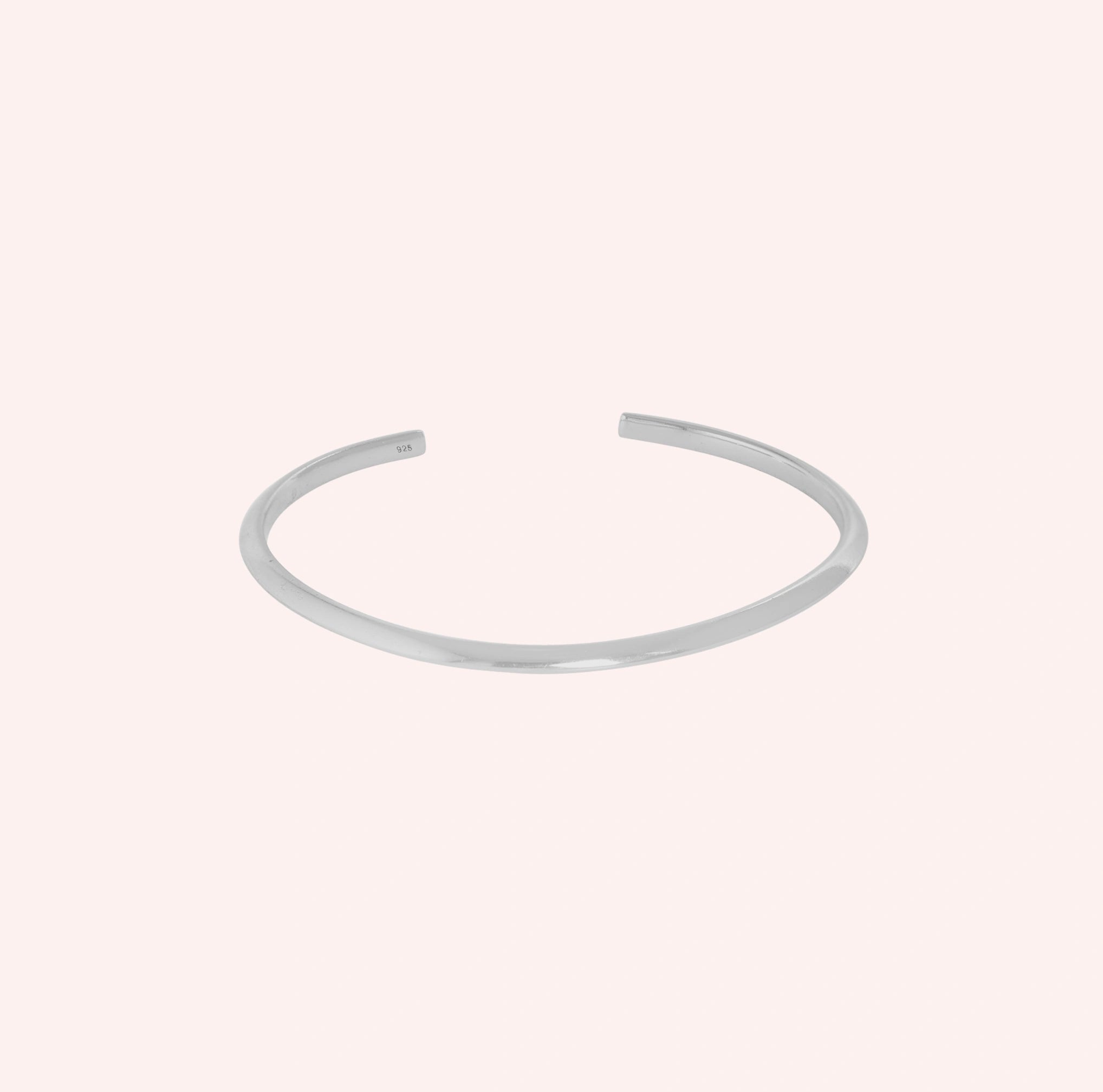 Plain_sterling_in_gold_plated_silver_at_front_angle_view_on_solid_pink_background