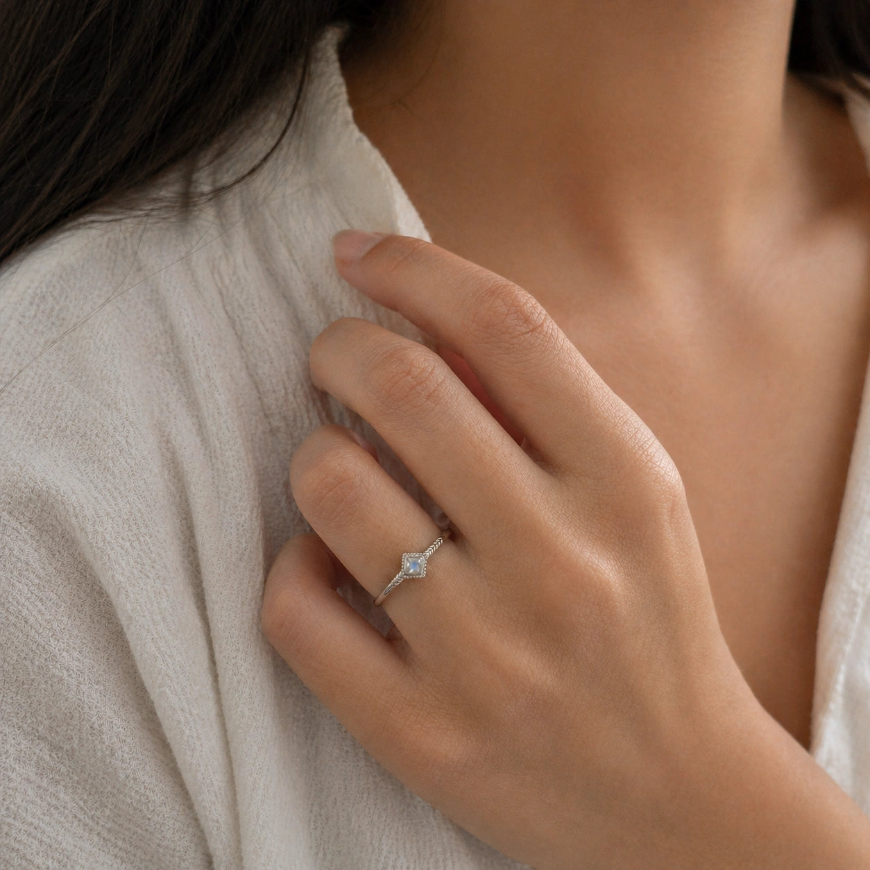 Princess_cut_ring_gold_plated_silver_with_square_moonstone_and_detailed_band_worn_by_a_model