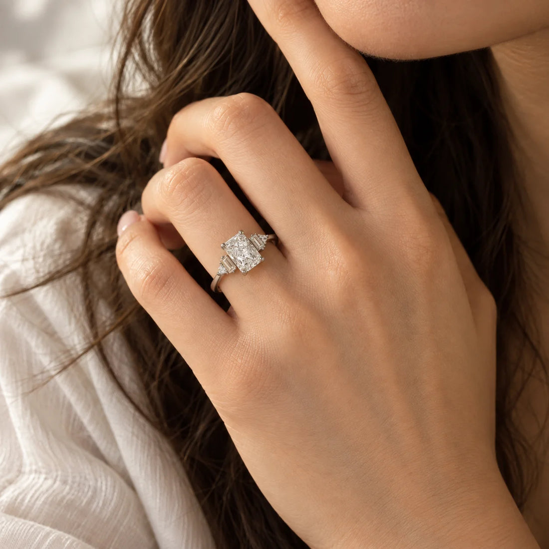 Promise_ring_in_gold_plated_silver_with_five_lab_grown_diamonds_at_front_view_on_soft_fabric_background