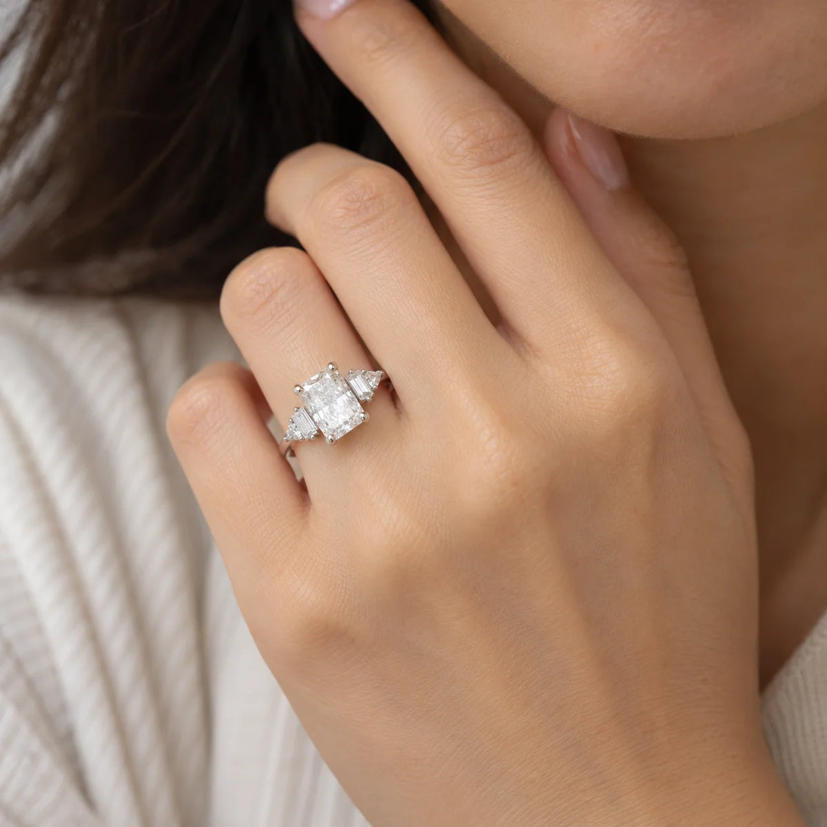 Promise_ring_in_sterling_silver_with_five_CZ_stones_at_front_view_worn_by_a_model