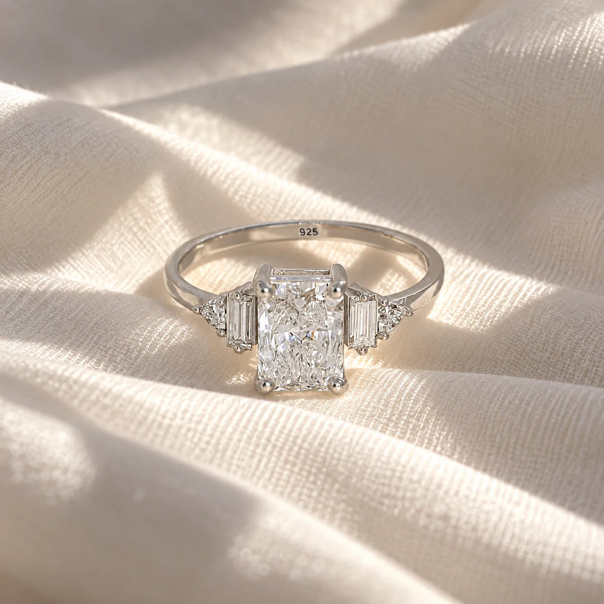 Promise_ring_in_sterling_silver_with_five_lab_grown_diamonds_at_front_view_on_soft_fabric_background