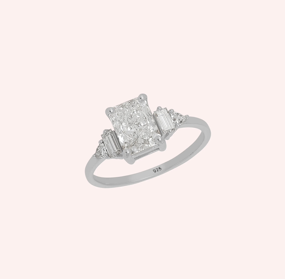 Promise_ring_in_sterling_silver_with_five_lab_grown_diamonds_at_slight_angled_view_on_solid_pink_background