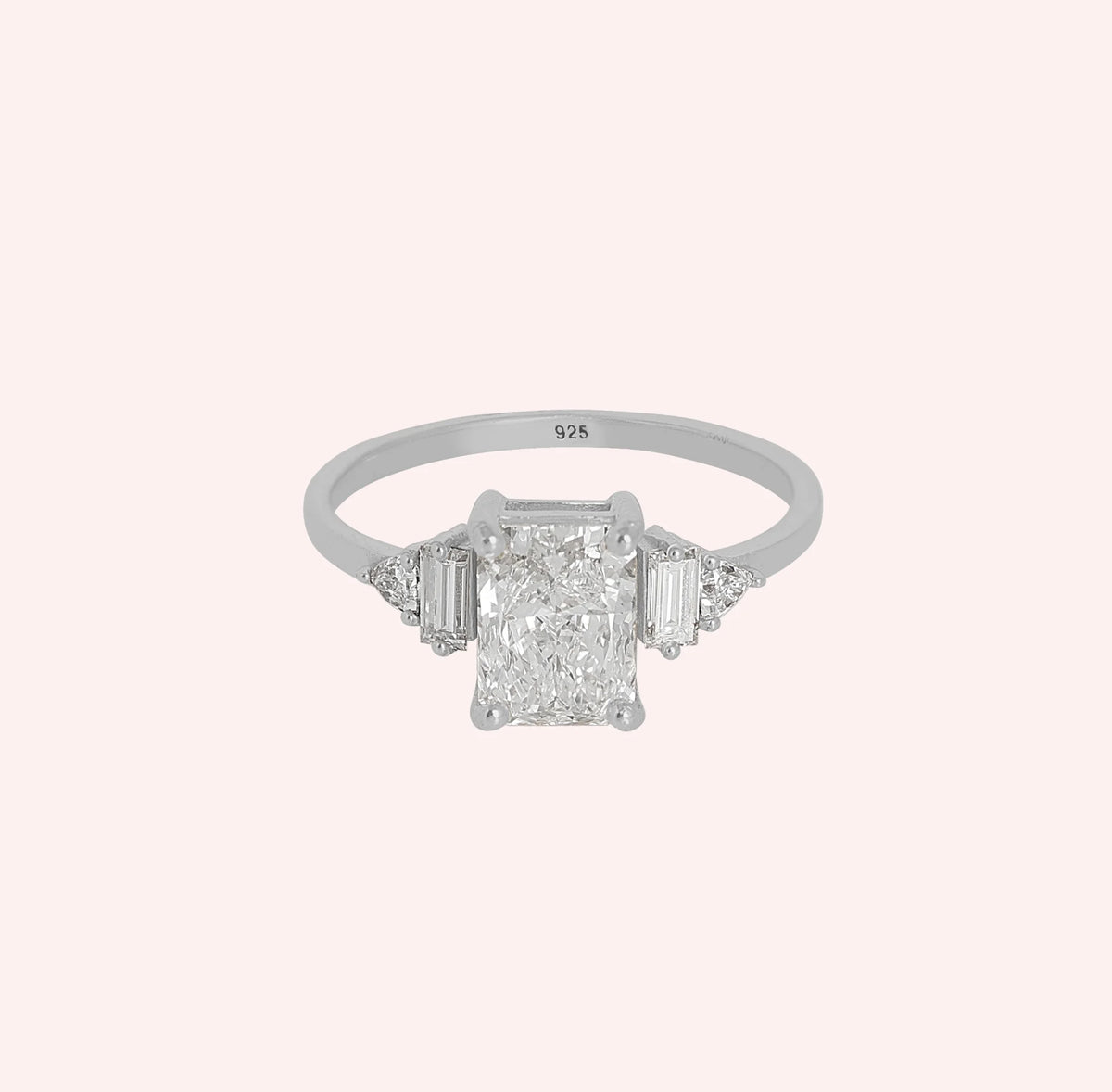 Promise_ring_in_sterling_silver_with_five_lab_grown_diamonds_at_front_angled_view_on_solid_pink_background