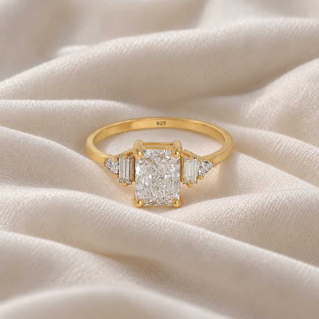 Promise_ring_in_gold_plated_silver_with_five_lab_grown_diamonds_at_front_view_on_soft_fabric_background