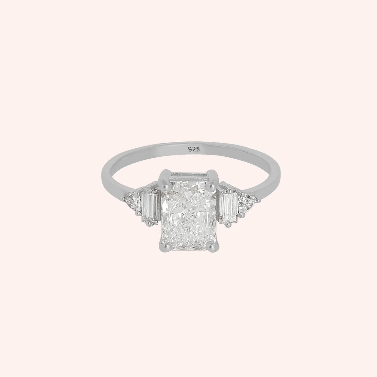 Promise_ring_in_sterling_silver_with_five_CZ_stones_at_front_view_on_solid_pink_background