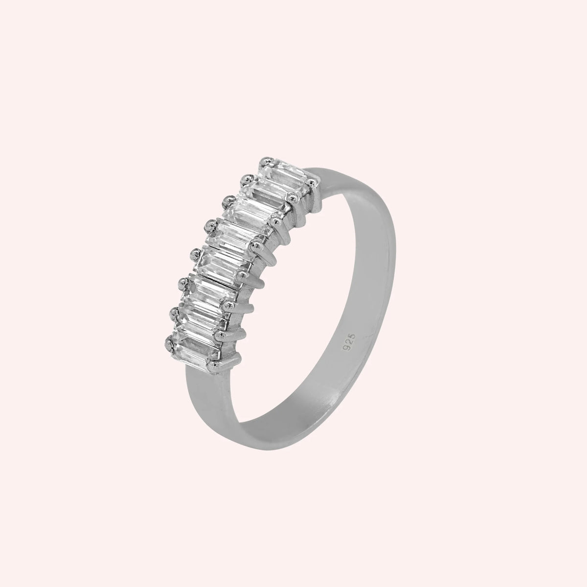 Promise_ring_in_sterling_silver_with_baguette_cut_lab_grown_diamonds_at_side_angle_view_on_solid_pink_background