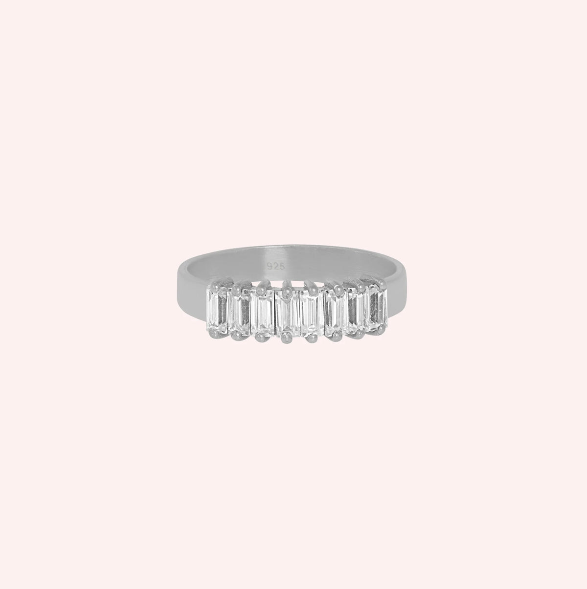 Promise_ring_in_sterling_silver_with_baguette_cut_lab_grown_diamonds_at_front_angle_view_on_solid_pink_background