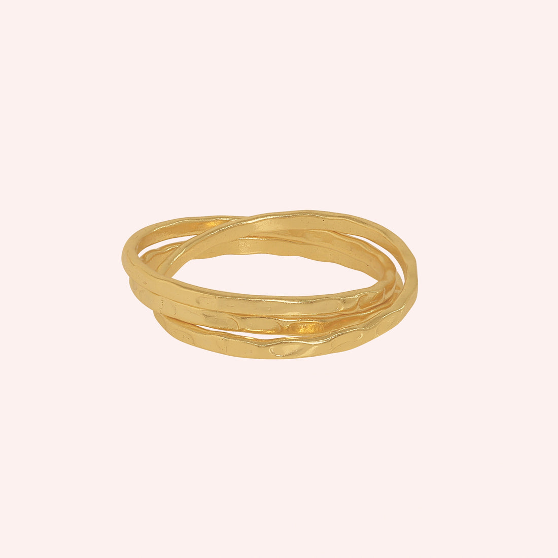 Ring_set_of_three_gold_plated_silver_textured_stacking_bands_at_front_angle_on_soft_fabric_background