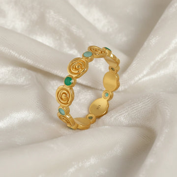 Rose-ring-with-green-and-blue-gemstones-gold-plated-silver-angled-view-on-white-satin-background
