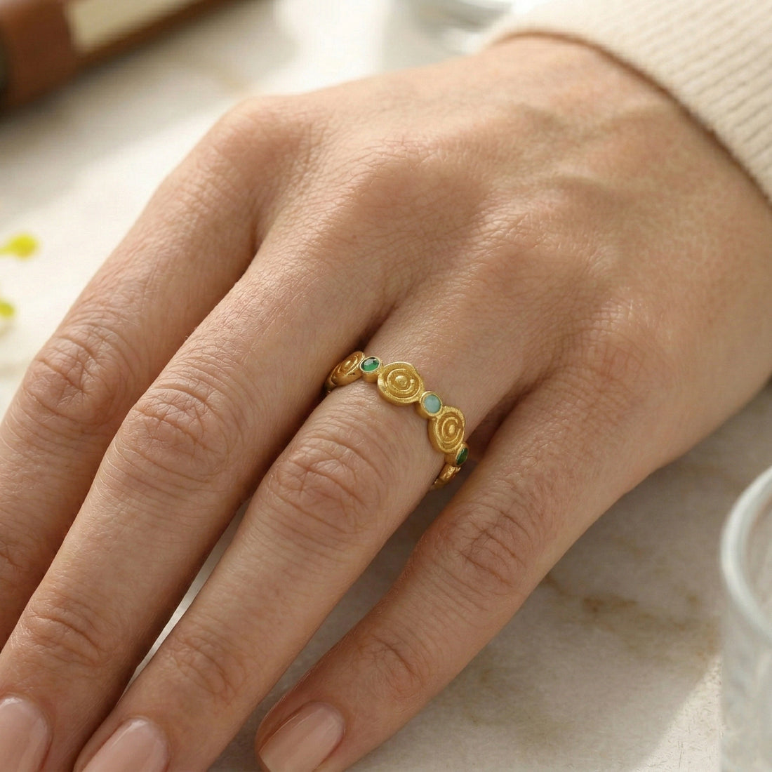 Rose-ring-with-green-and-blue-gemstones-gold-plated-silver-angled-view-on-white-satin-background