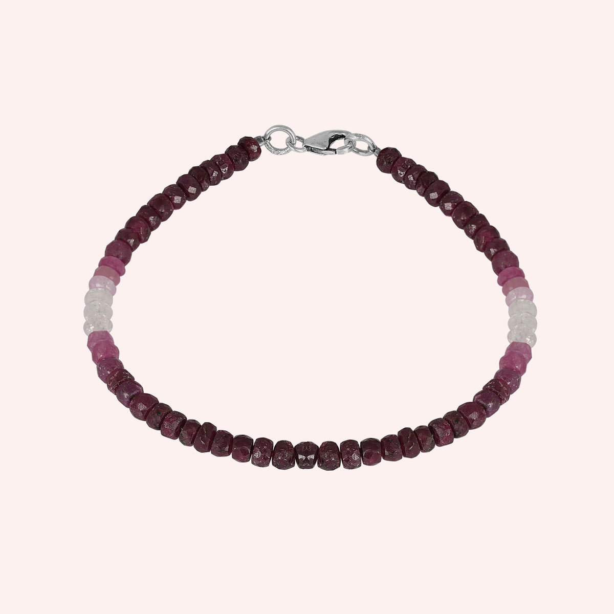 Ruby_bracelet_in_ombre_effect_with_ruby_stones_in_gradient_design_in_front_angle_on_solid_pink_background