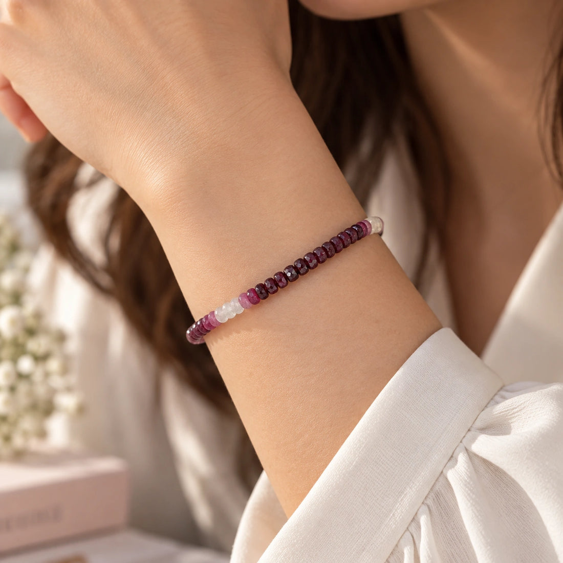 Ruby_bracelet_in_ombre_effect_with_ruby_stones_in_gradient_design_in_front_angle_on_a_white_fabric_background