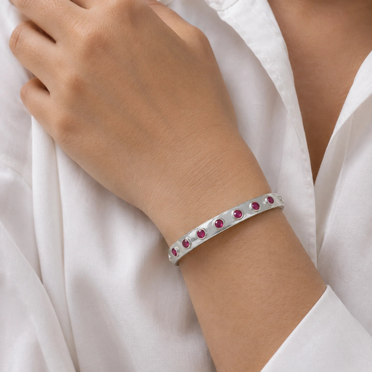 Ruby_bracelet_in_sterling_silver_with_round_ruby_stones_worn_by_a_model