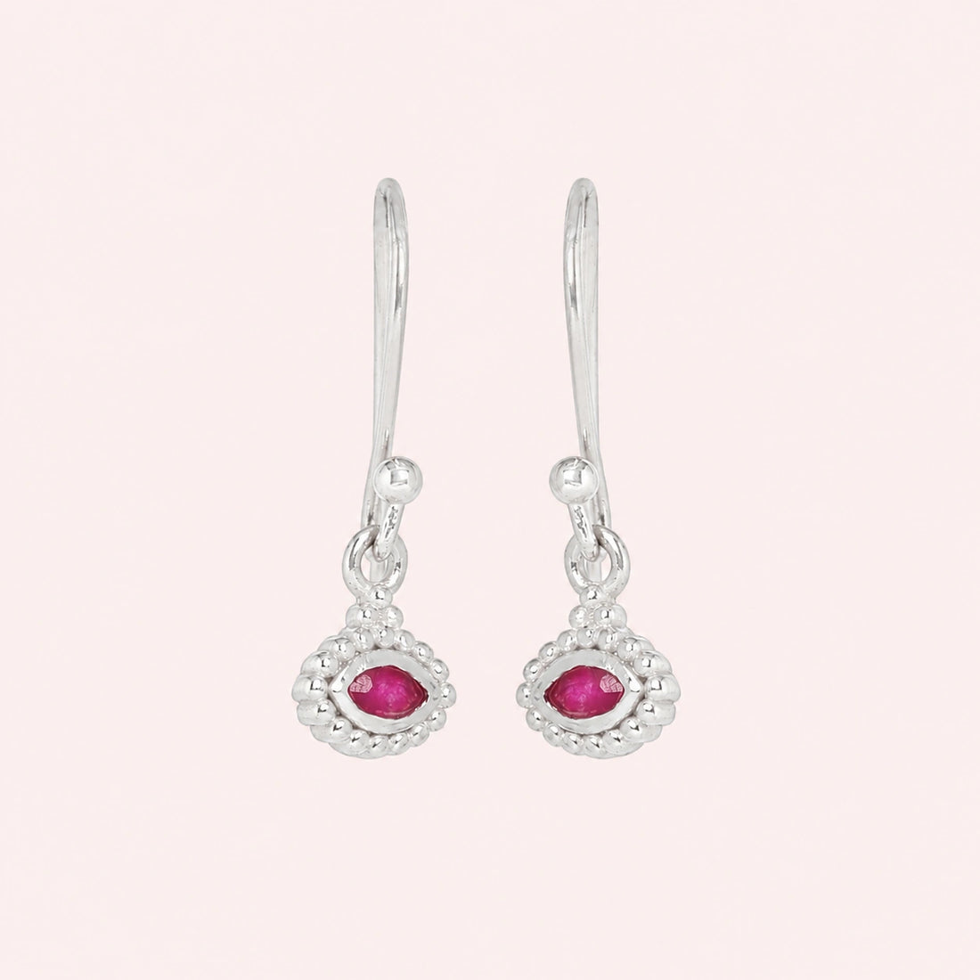 Ruby_earrings_in_gold_plated_silver_with_marquise_ruby_stone_at_front_angle_view_on_solid_pink_background