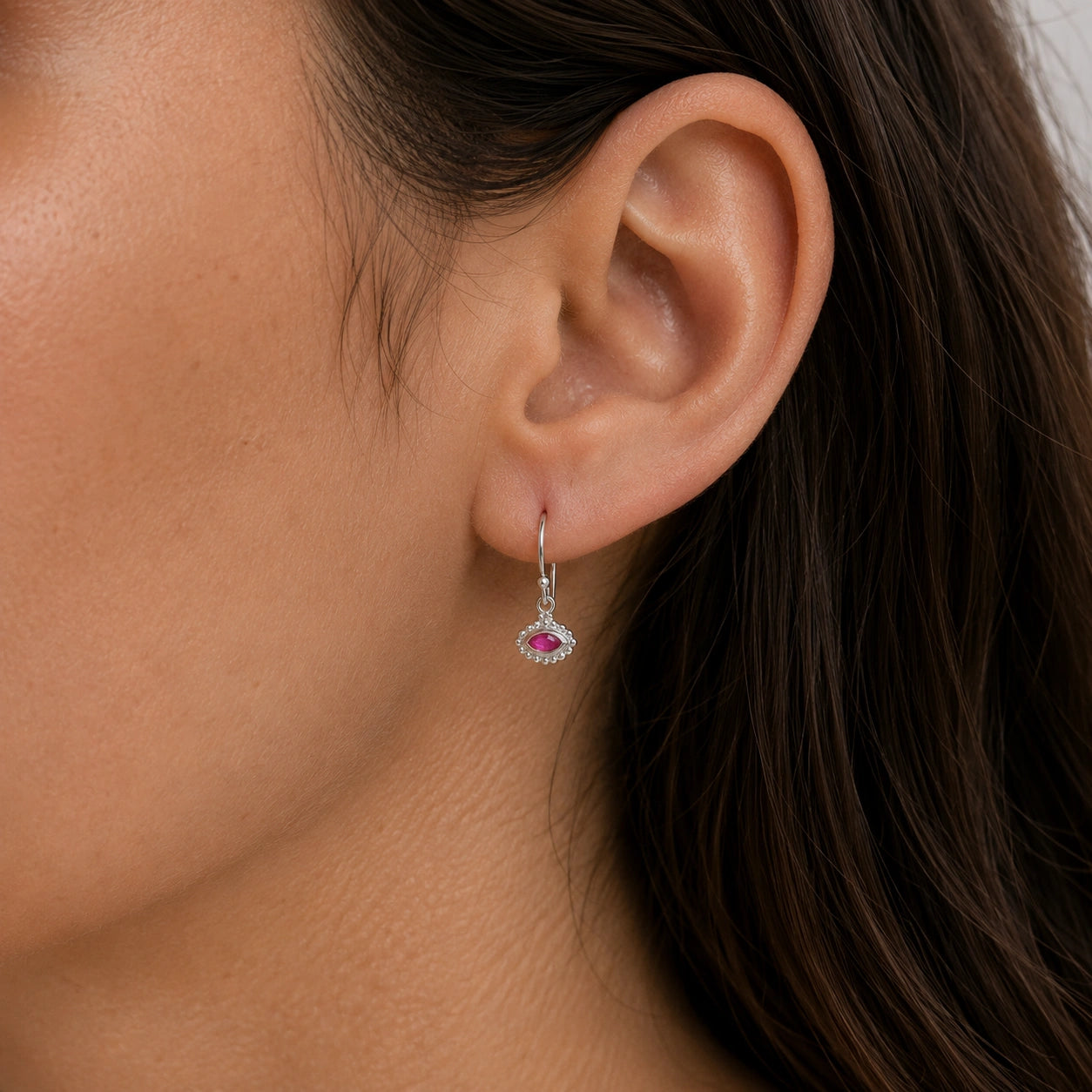Ruby_earrings_in_sterling_silver_with_marquise_ruby_stone_worn_by_a_model