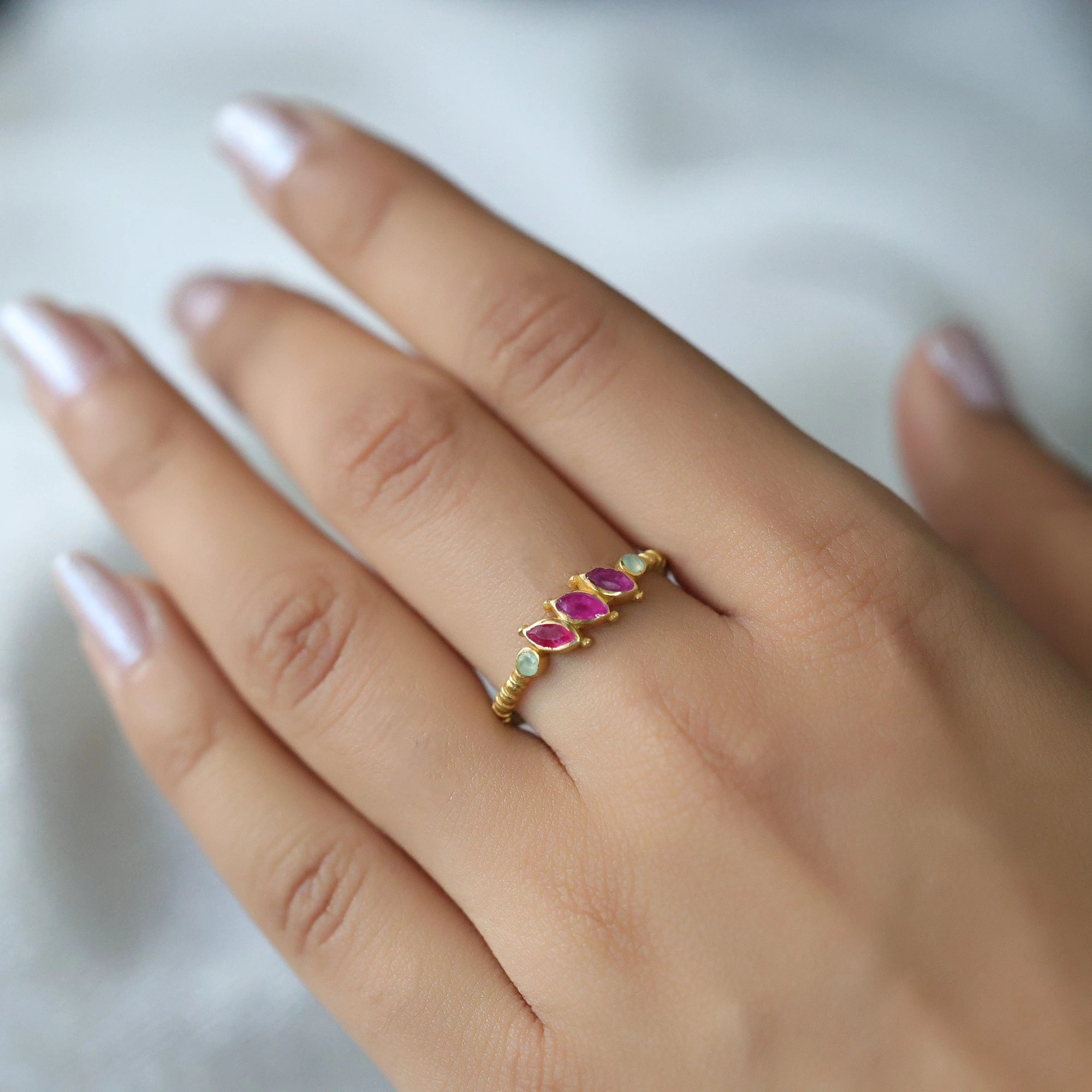 Ruby-ring-with-pink-and-green-gemstones-gold-plated-silver-worn-by-a-model-in-natural-light
