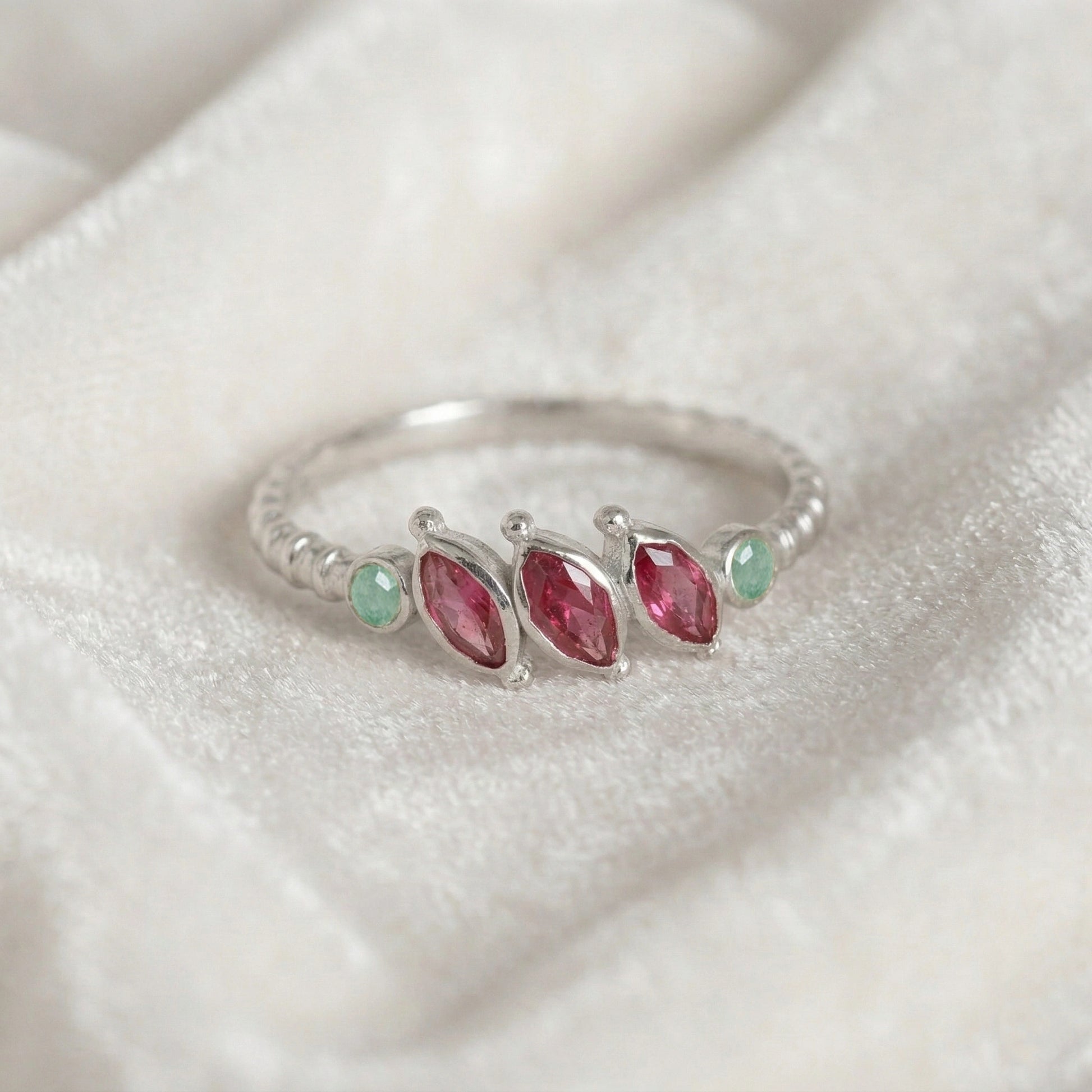 Ruby-ring-with-pink-and-green-gemstones-sterling-silver-front-view-on-white-satin-background