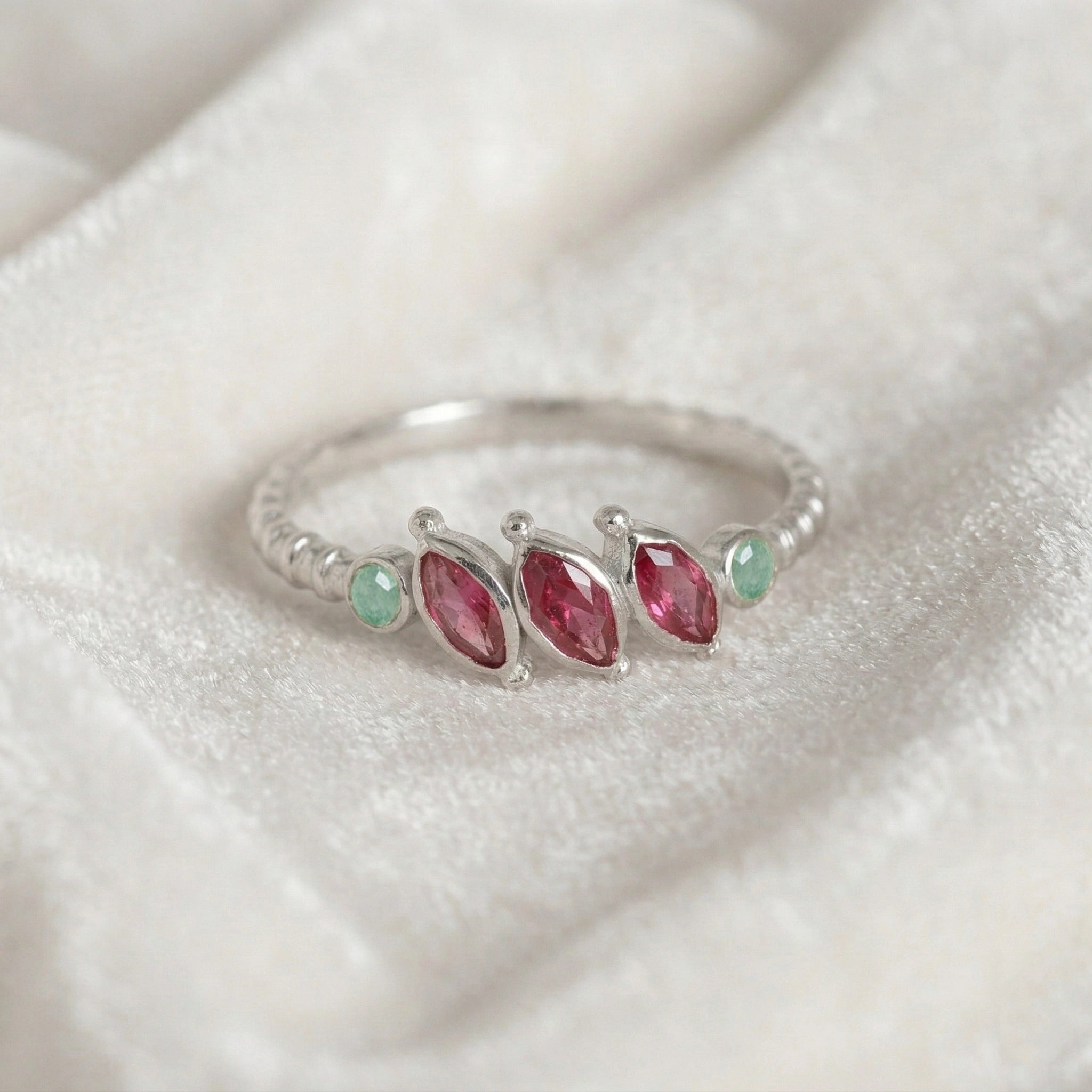 Ruby-ring-with-pink-and-green-gemstones-sterling-silver-front-view-on-white-satin-background