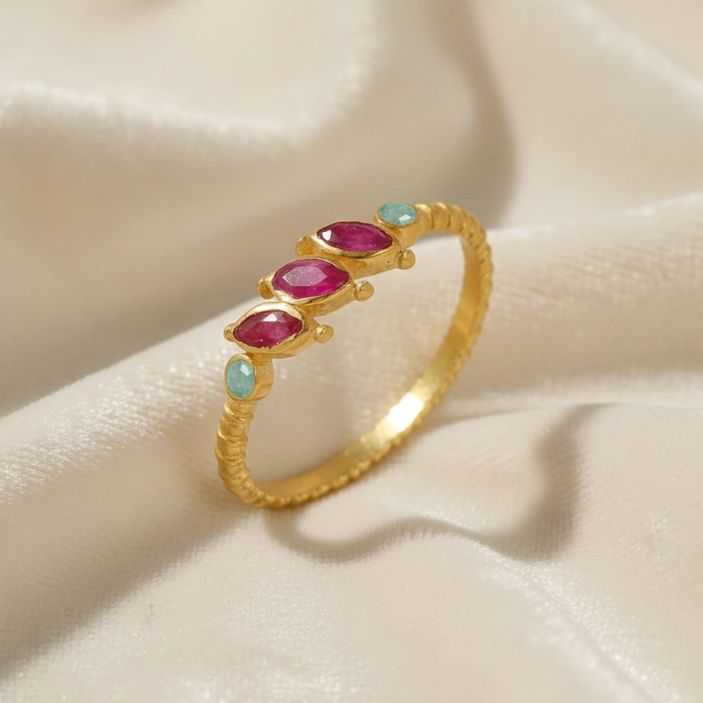 Ruby-ring-with-pink-and-green-gemstones-gold-plated-silver-angled-view-on-white-satin-background