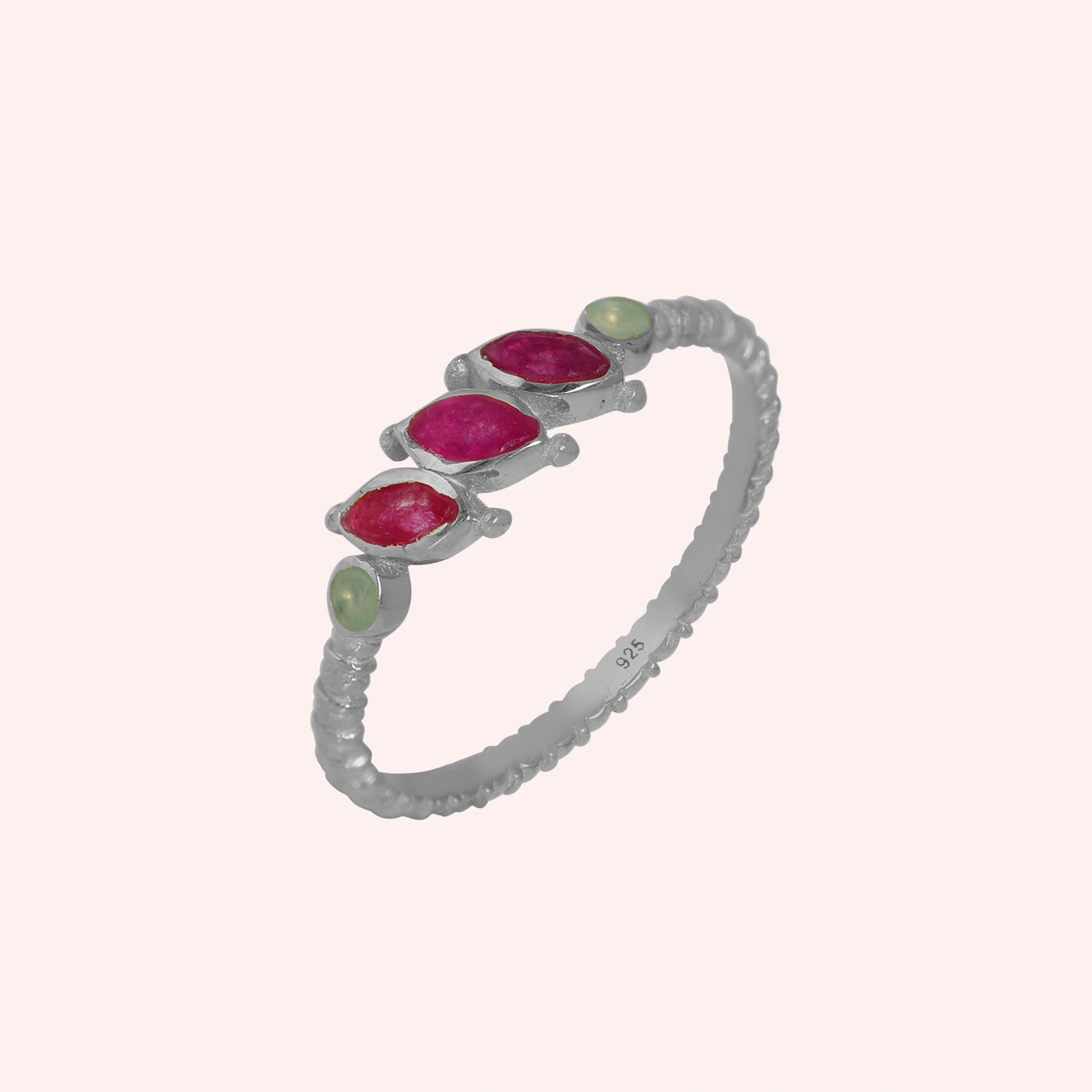 Ruby-ring-with-pink-and-green-gemstones-sterling-silver-angled-view-on-solid-pink-background