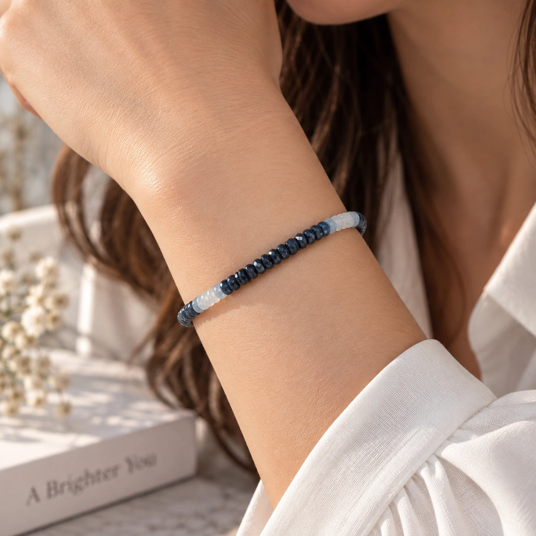 Sapphire_bracelet_in_ombre_effect_with_sapphire_stones_in_gradient_design_in_front_angle_on_a_white_fabric_background