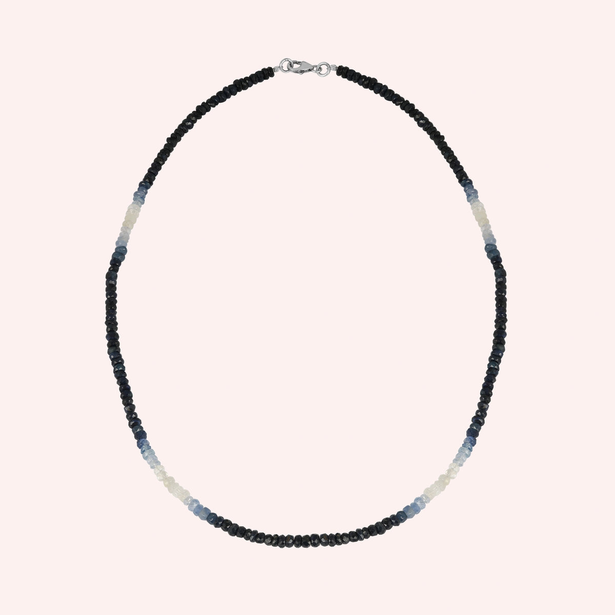 Sapphire_necklace_in_ombre_effect_with_sapphire_stones_in_gradient_design_in_front_angle_on_solid_pink_background