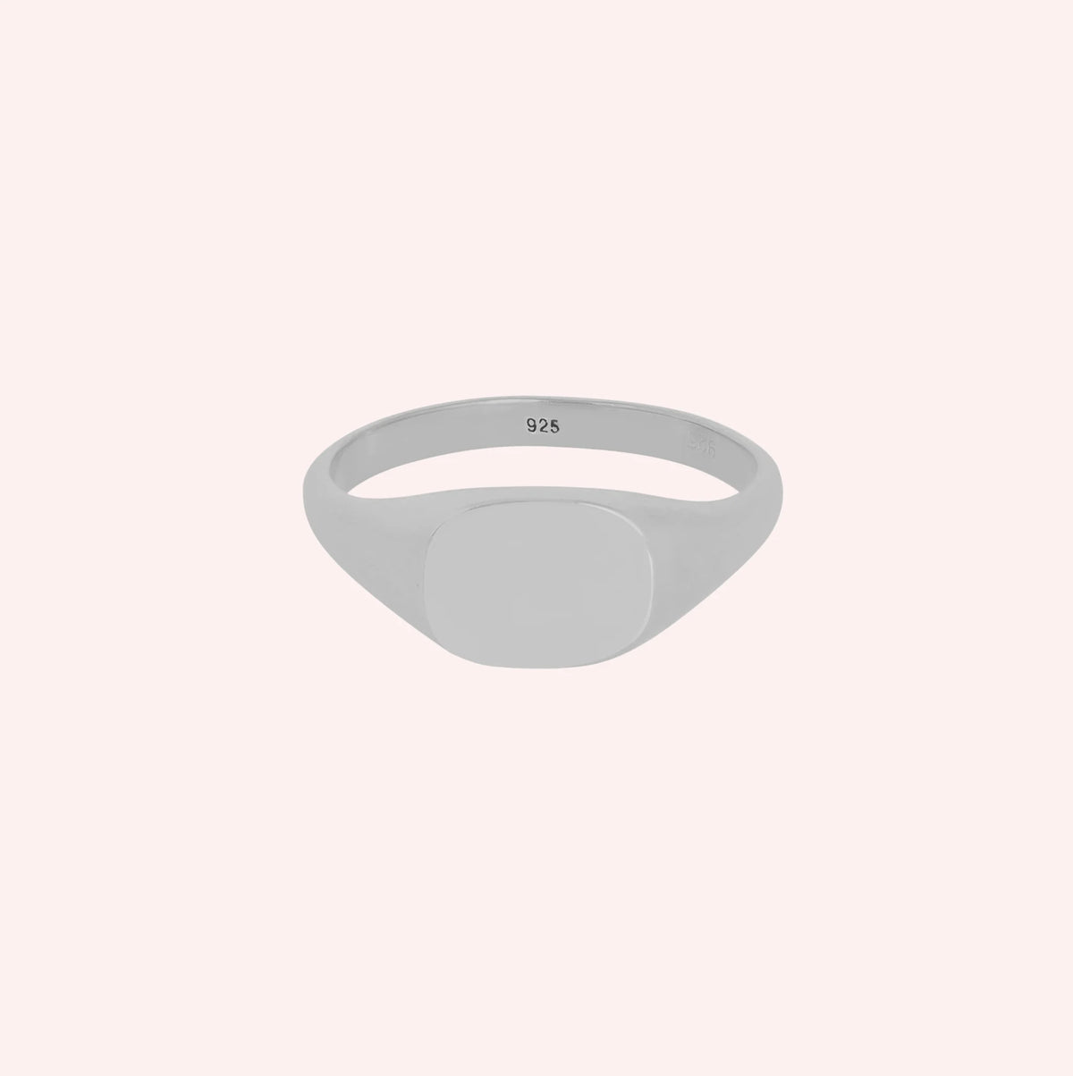 Signet_ring_in_sterling_silver_with_at_front_angle_view_on_solid_pink_background