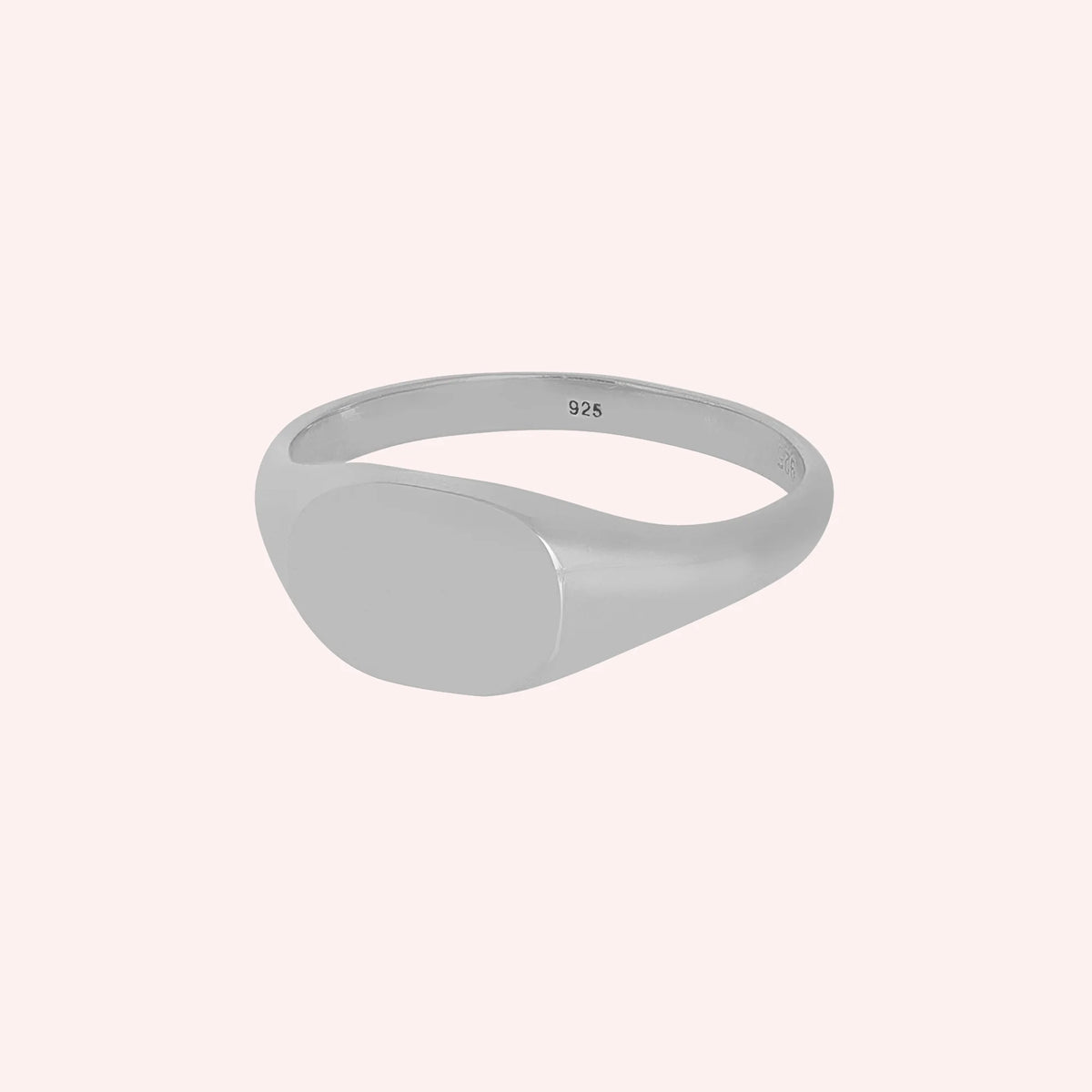Signet_ring_in_sterling_silver_with_at_slight_angle_view_on_solid_pink_background