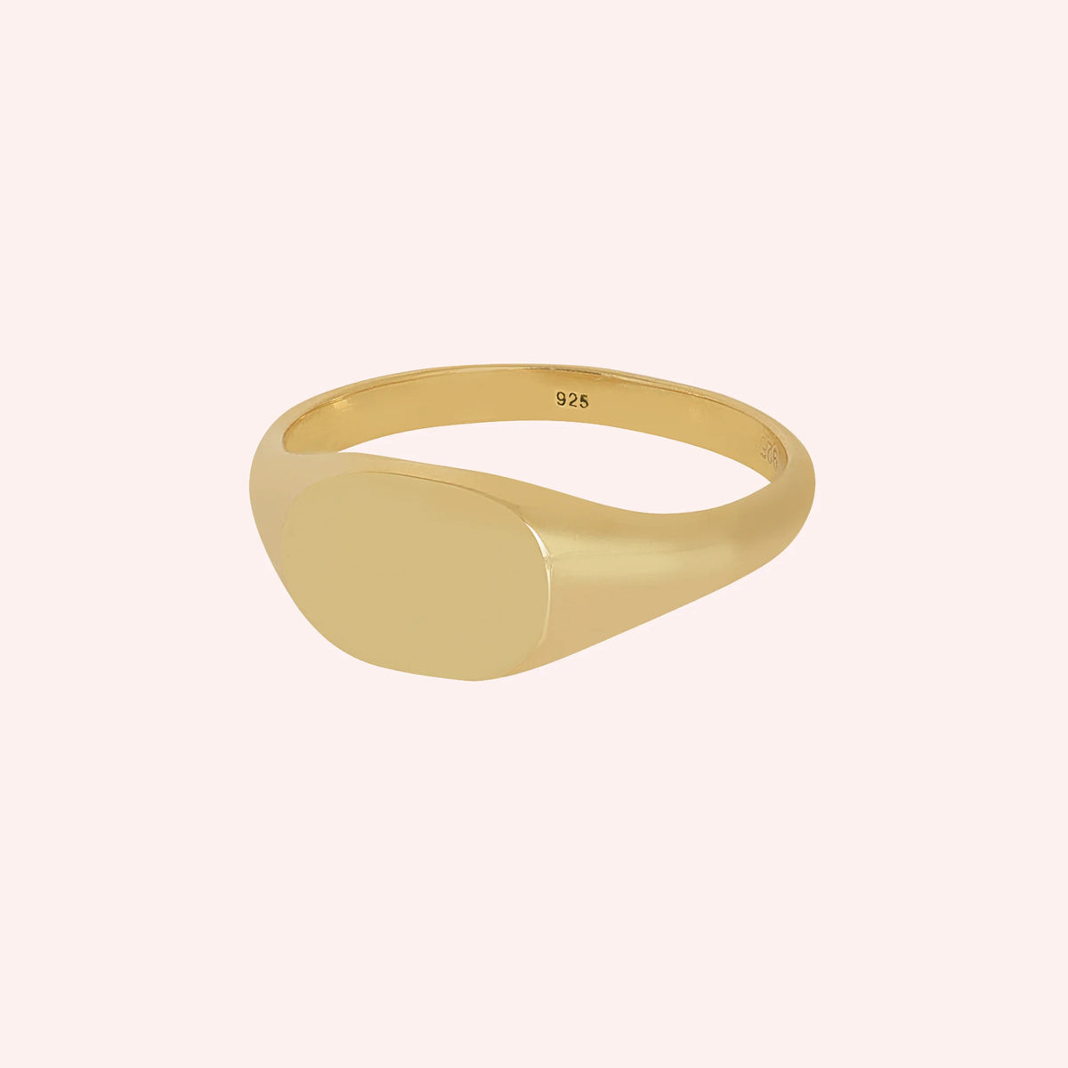 Signet_ring_in_gold_plated_silver_with_at_slight_angle_view_on_solid_pink_background