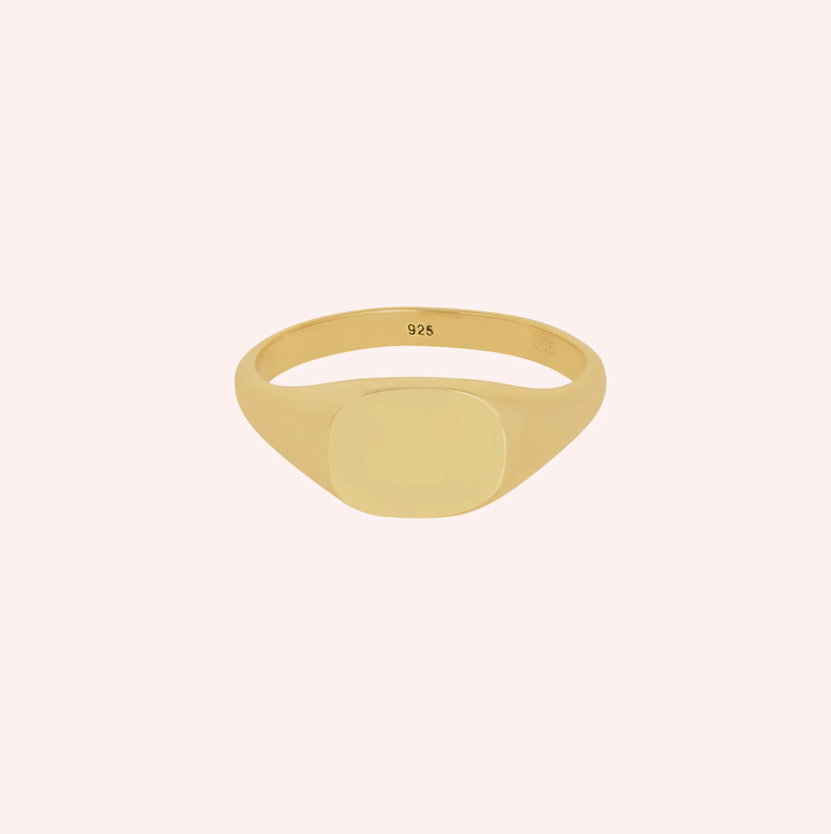 Signet_ring_in_gold_plated_silver_with_at_front_angle_view_on_solid_pink_background