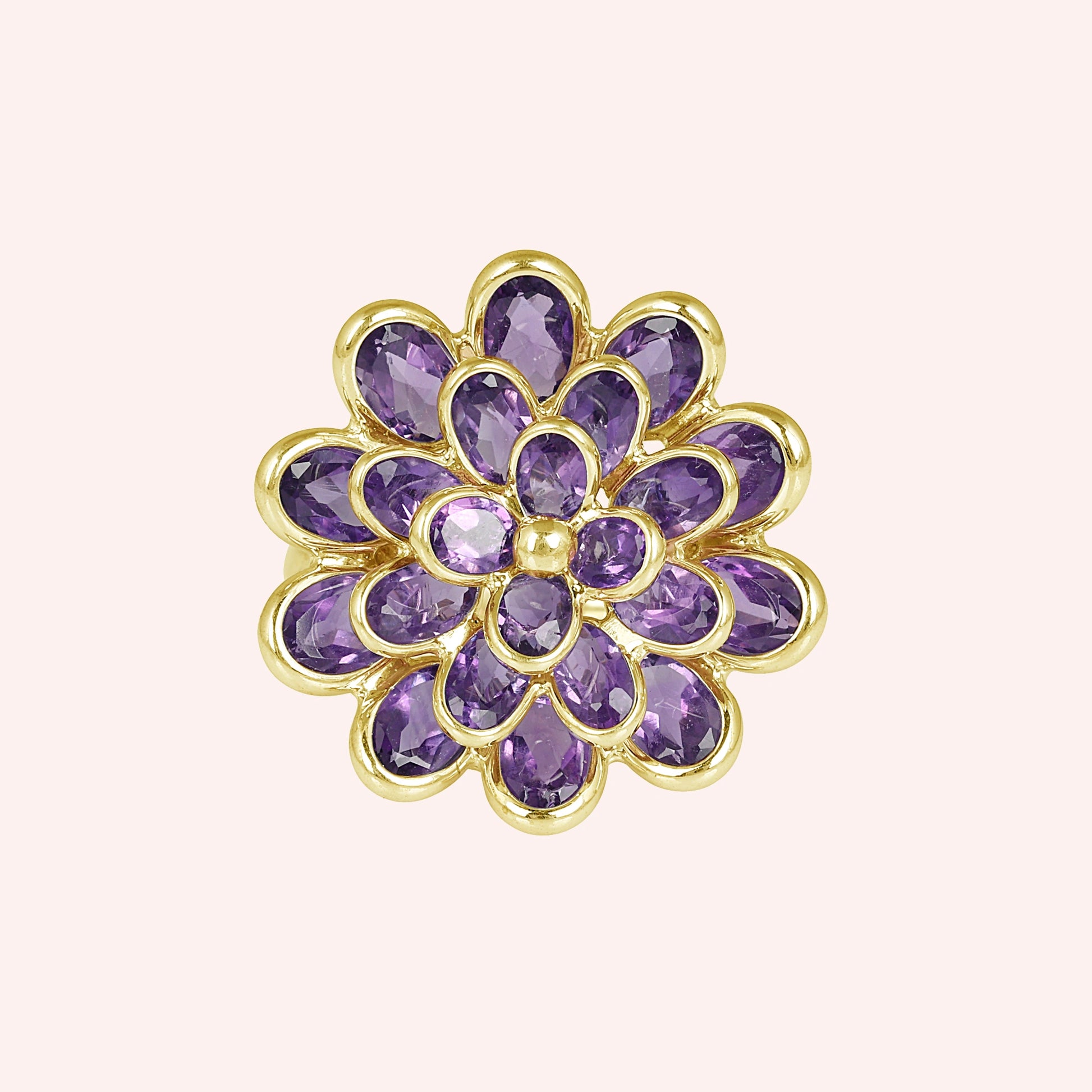 silver_flower_ring_flower_engagement_ring_top_view_with_purple_gem_petals_in_gold_plated_setting_on_soft_pink_background