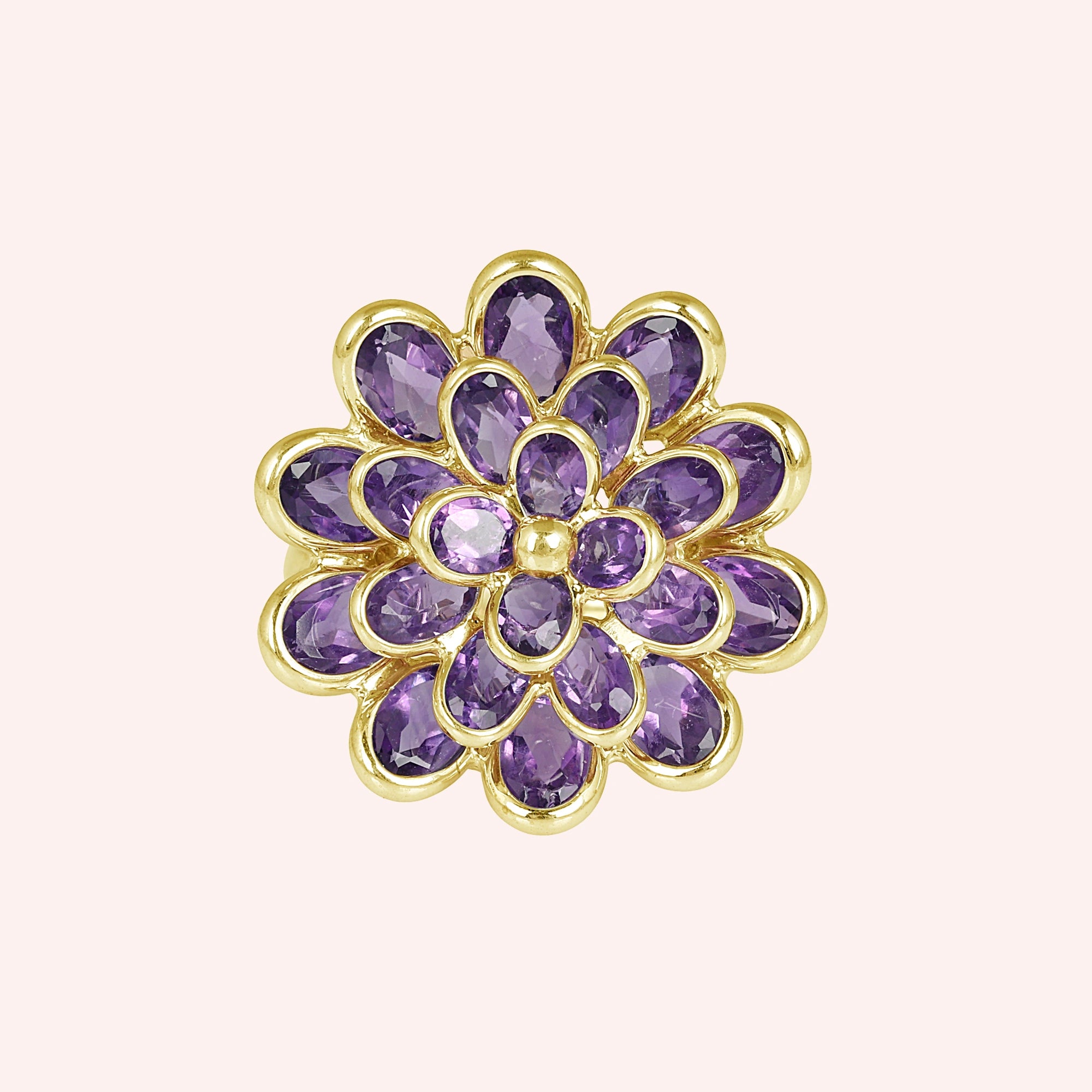 silver_flower_ring_flower_engagement_ring_top_view_with_purple_gem_petals_in_gold_plated_setting_on_soft_pink_background