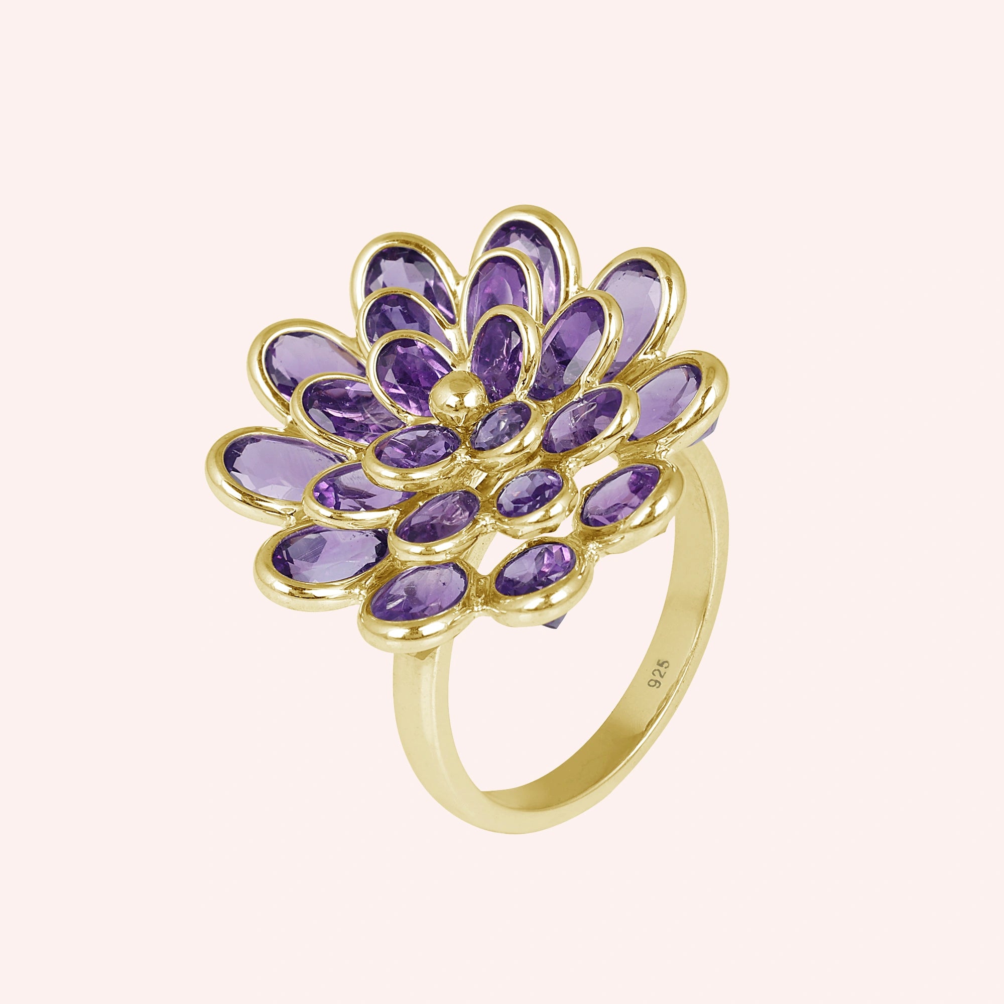 silver_flower_ring_flower_engagement_ring_gold_plated_with_purple_gem_petals_in_silver_setting_angled_view_on_pink_background