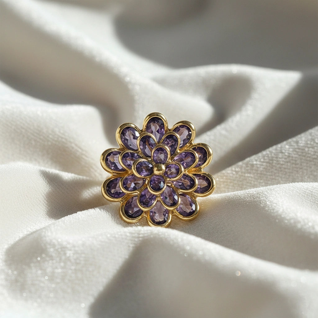 silver_flower_ring_flower_engagement_ring_with_purple_gem_petals_in_gold_plated_setting_top_view_on_soft_white_fabric_background