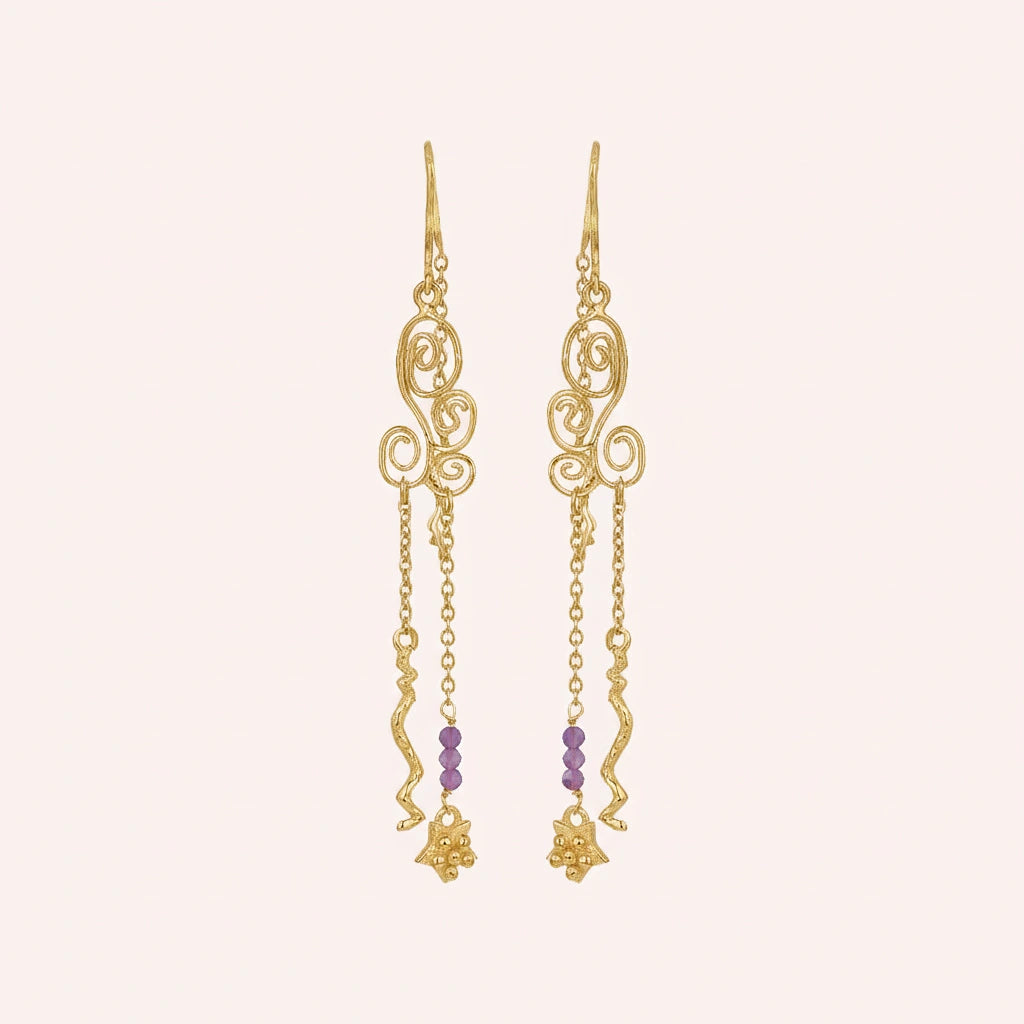 front_angle_silver_hanging_earrings_gold_plated_scroll_design_with_purple_beads_showing_trendy_earrings_on_soft_background