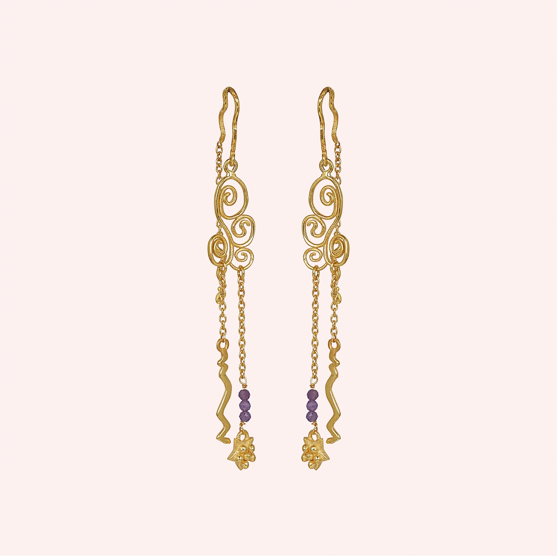 front_angle_gold_plated_silver_hanging_earrings_with_scroll_design_and_purple_beads_trendy_earrings_on_soft_blush_background