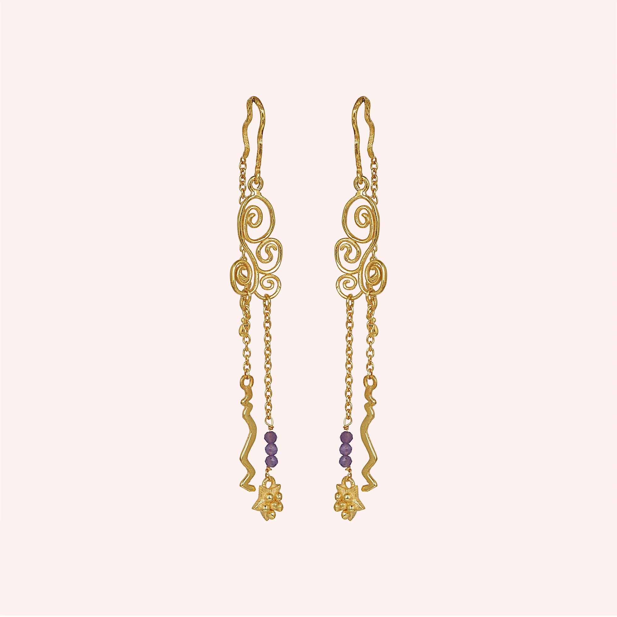 front_angle_gold_plated_silver_hanging_earrings_with_scroll_design_and_purple_beads_trendy_earrings_on_soft_blush_background