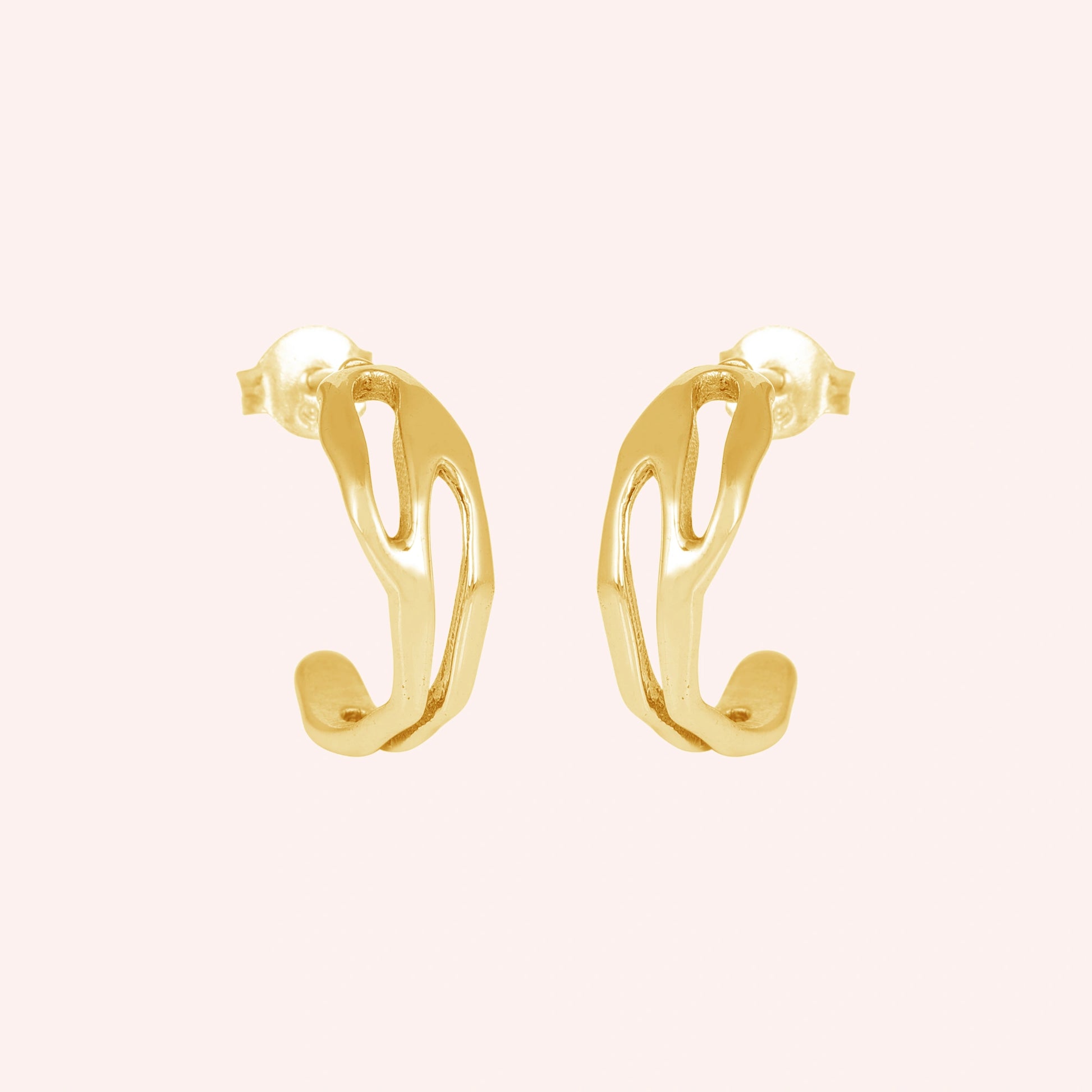 gold plated hoop earrings shown at front angled view featuring sculpted open hoop design on a soft pink background