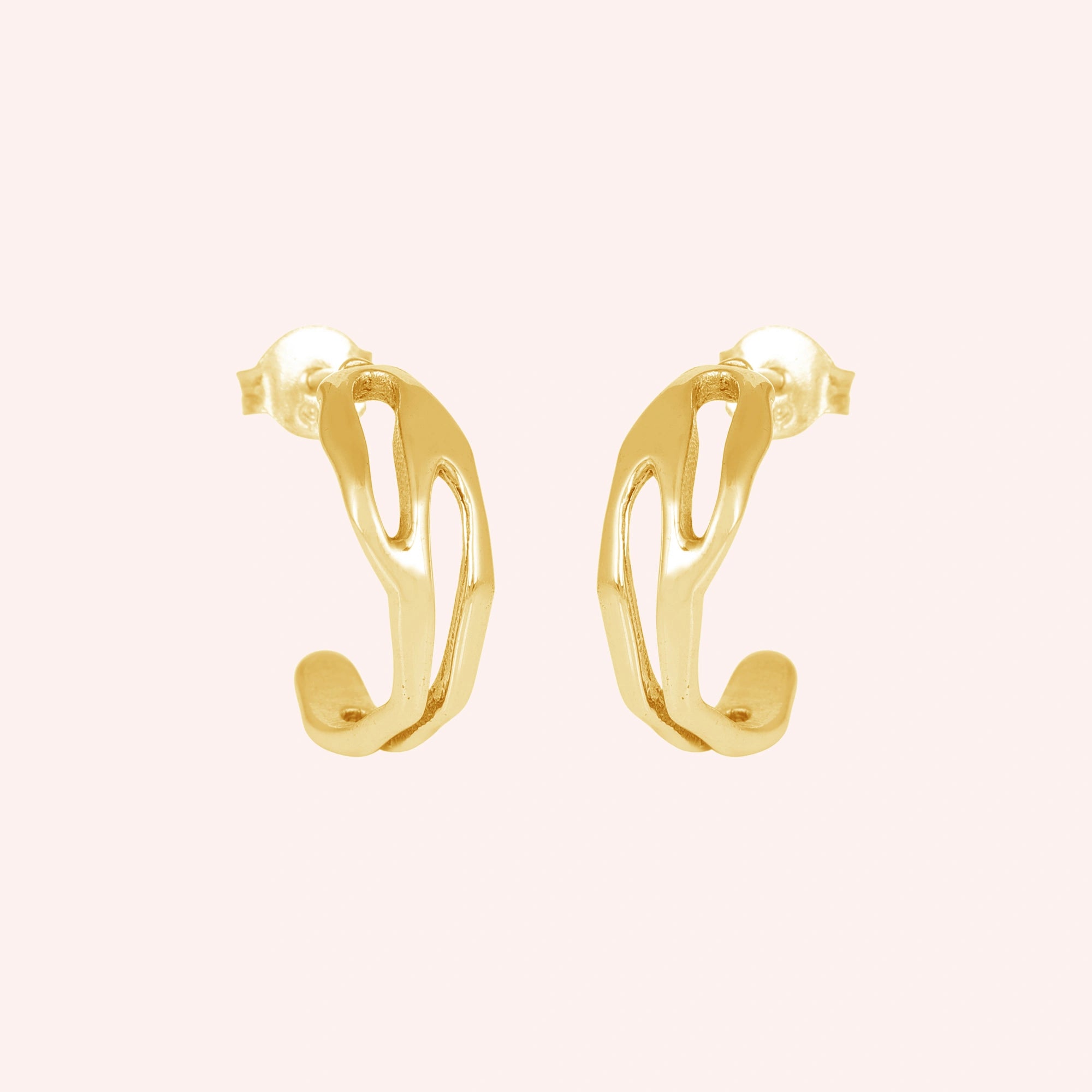 gold plated hoop earrings shown at front angled view featuring sculpted open hoop design on a soft pink background