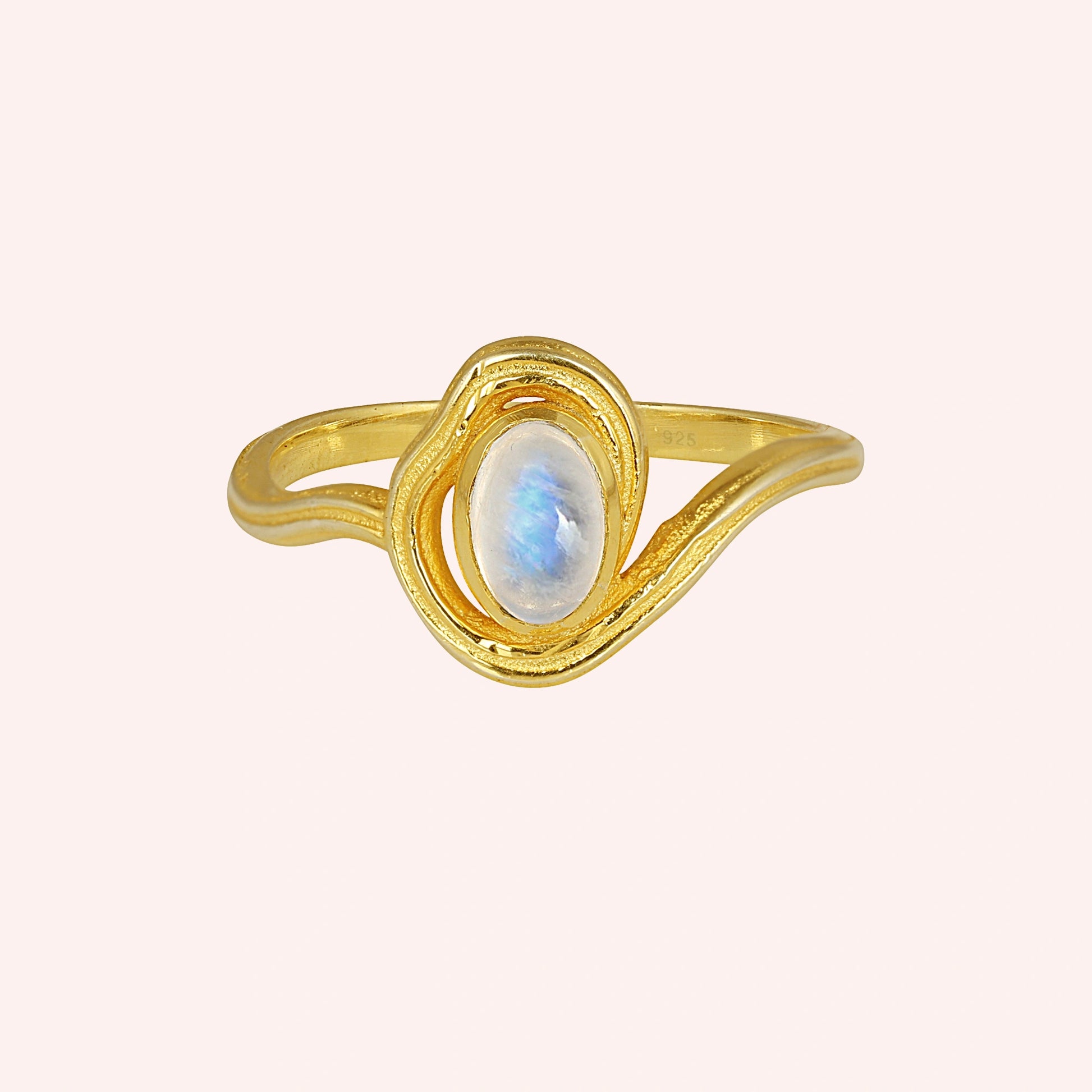 Moonstone_ring_with_gold_plated_silver_wave_band_at_front_angle_on_solid_pink_background