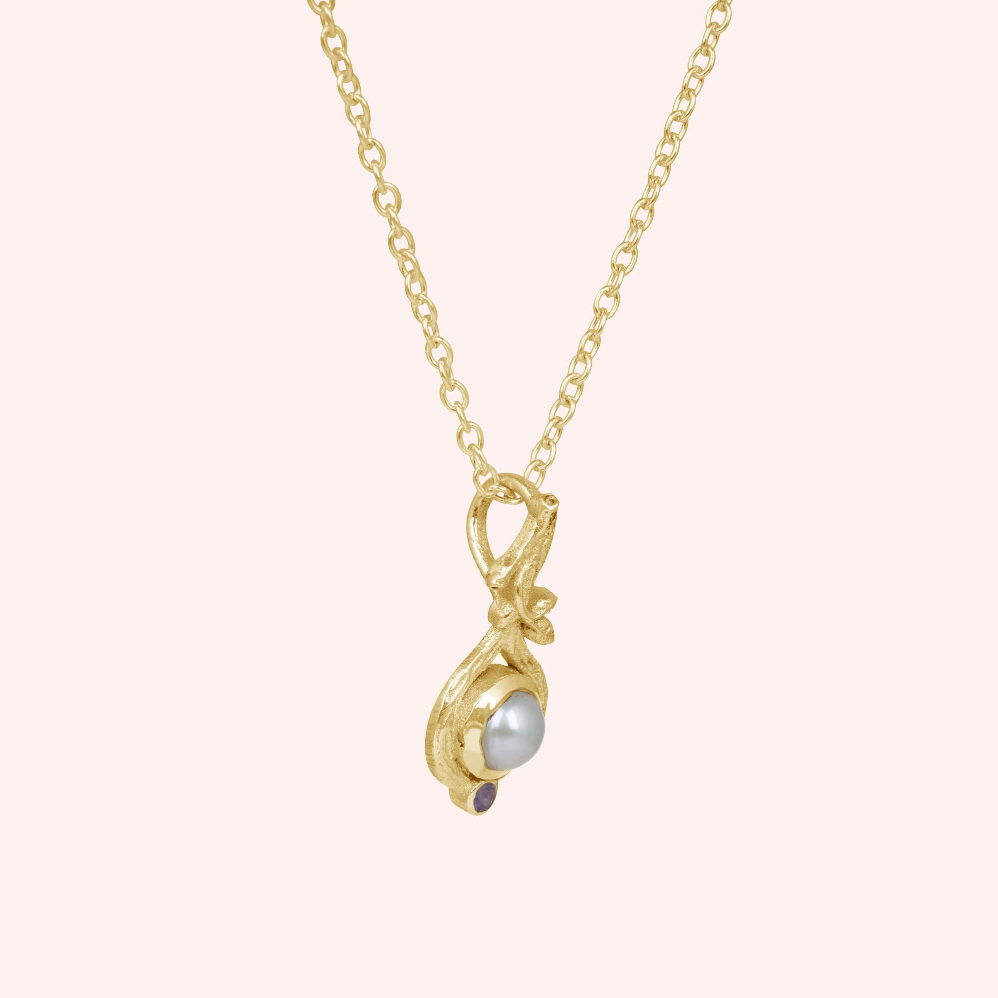 Side_view_gold_plated_silver_pearl_necklace_with_pearl_and_amethyst_accent_amethyst_pearl_necklace_on_soft_pink_background