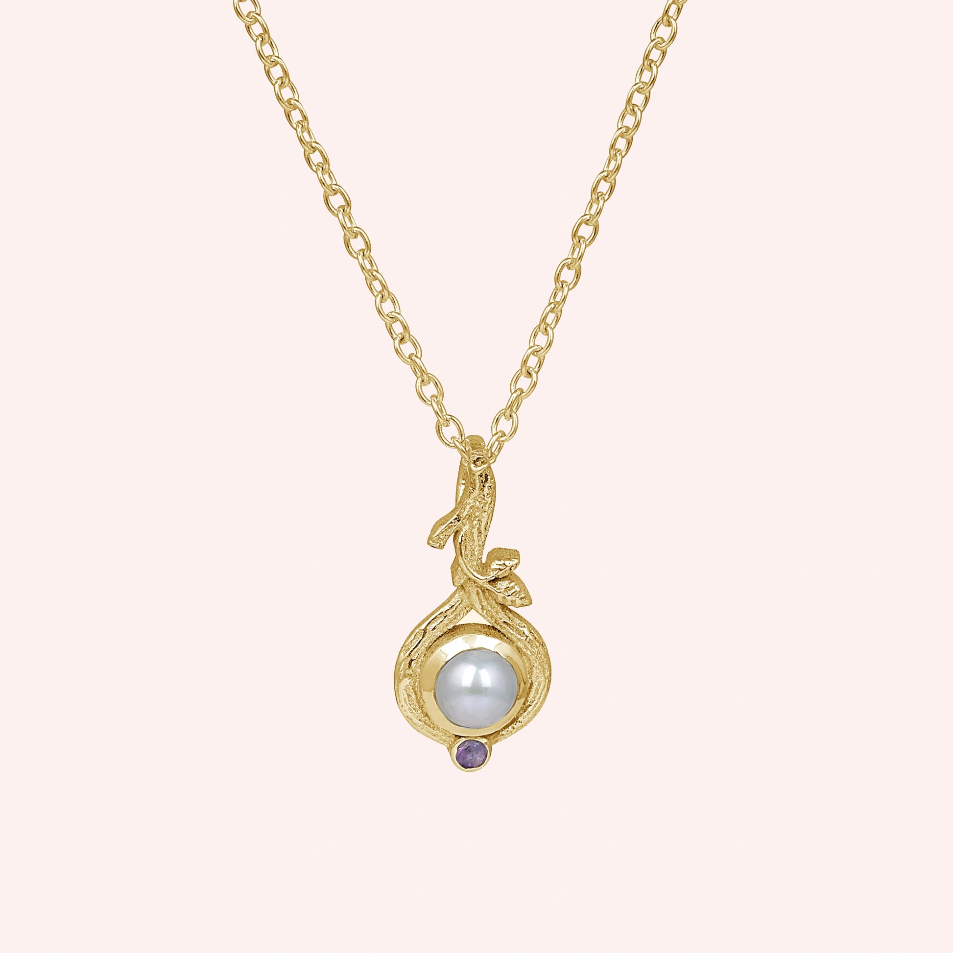 Front_view_gold_plated_silver_pearl_necklace_with_round_pearl_and_amethyst_accent_amethyst_pearl_necklace_on_soft_pink_background