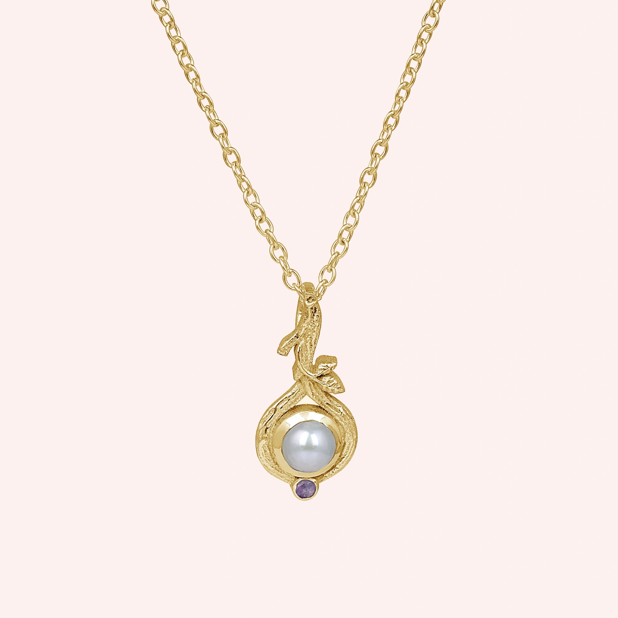 Front_view_gold_plated_silver_pearl_necklace_with_round_pearl_and_amethyst_accent_amethyst_pearl_necklace_on_soft_pink_background