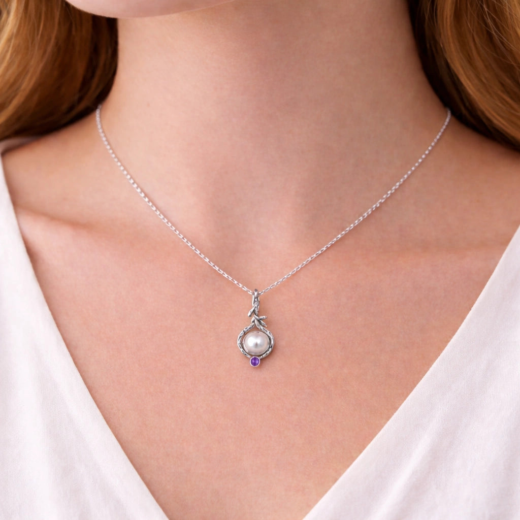 Front_angle_silver_pearl_necklace_with_round_pearl_and_amethyst_accent_amethyst_pearl_necklace_on_soft_satin_background
